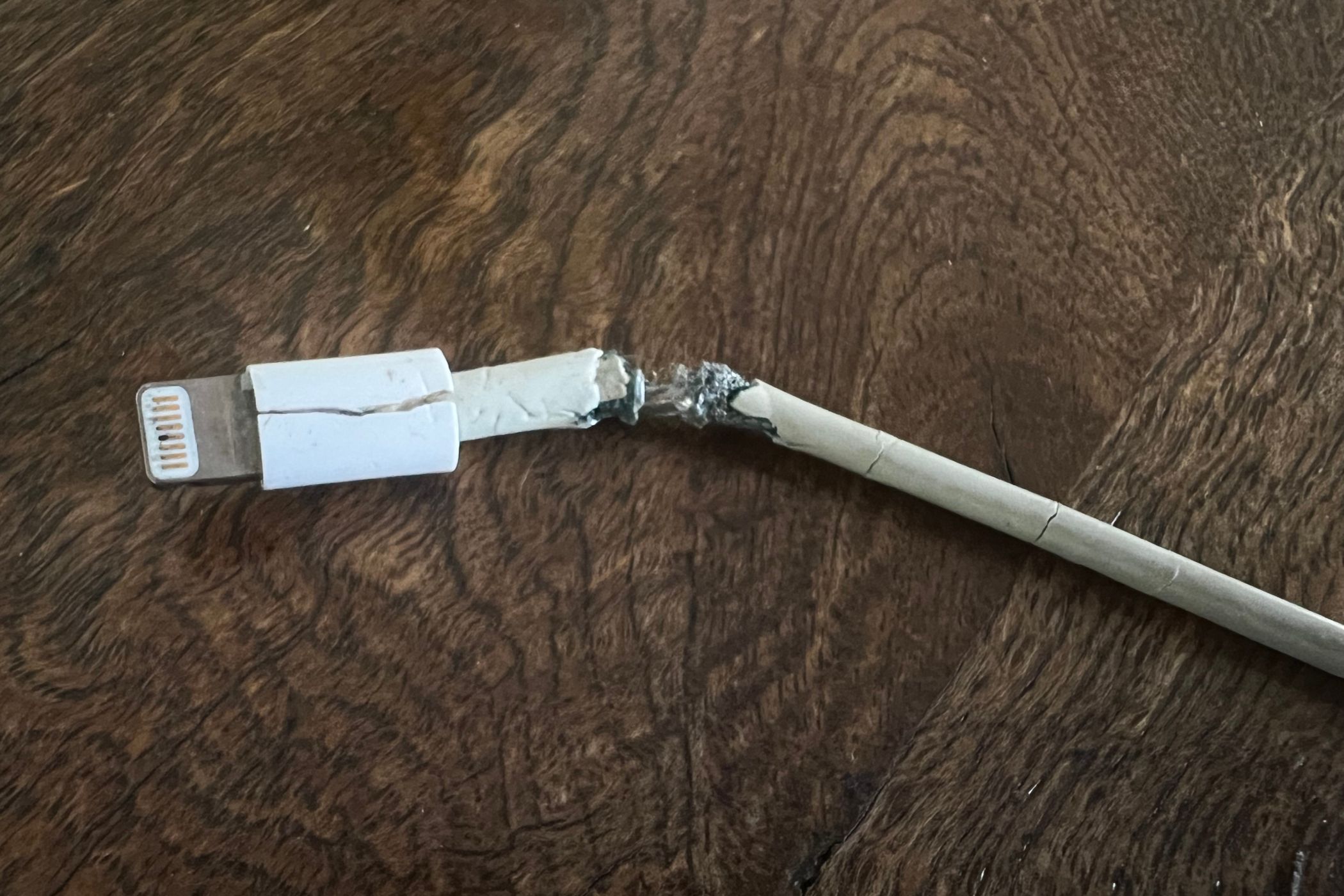 A cracked and frayed Lightning cable you definitely shouldn't use.
