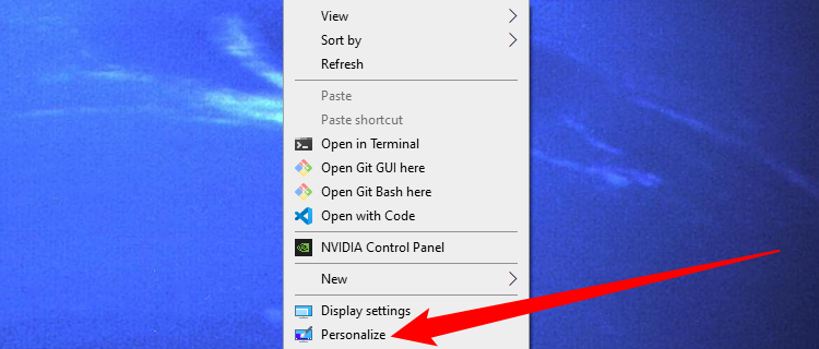 Right-click empty space on your desktop, then select 'Personalize.'