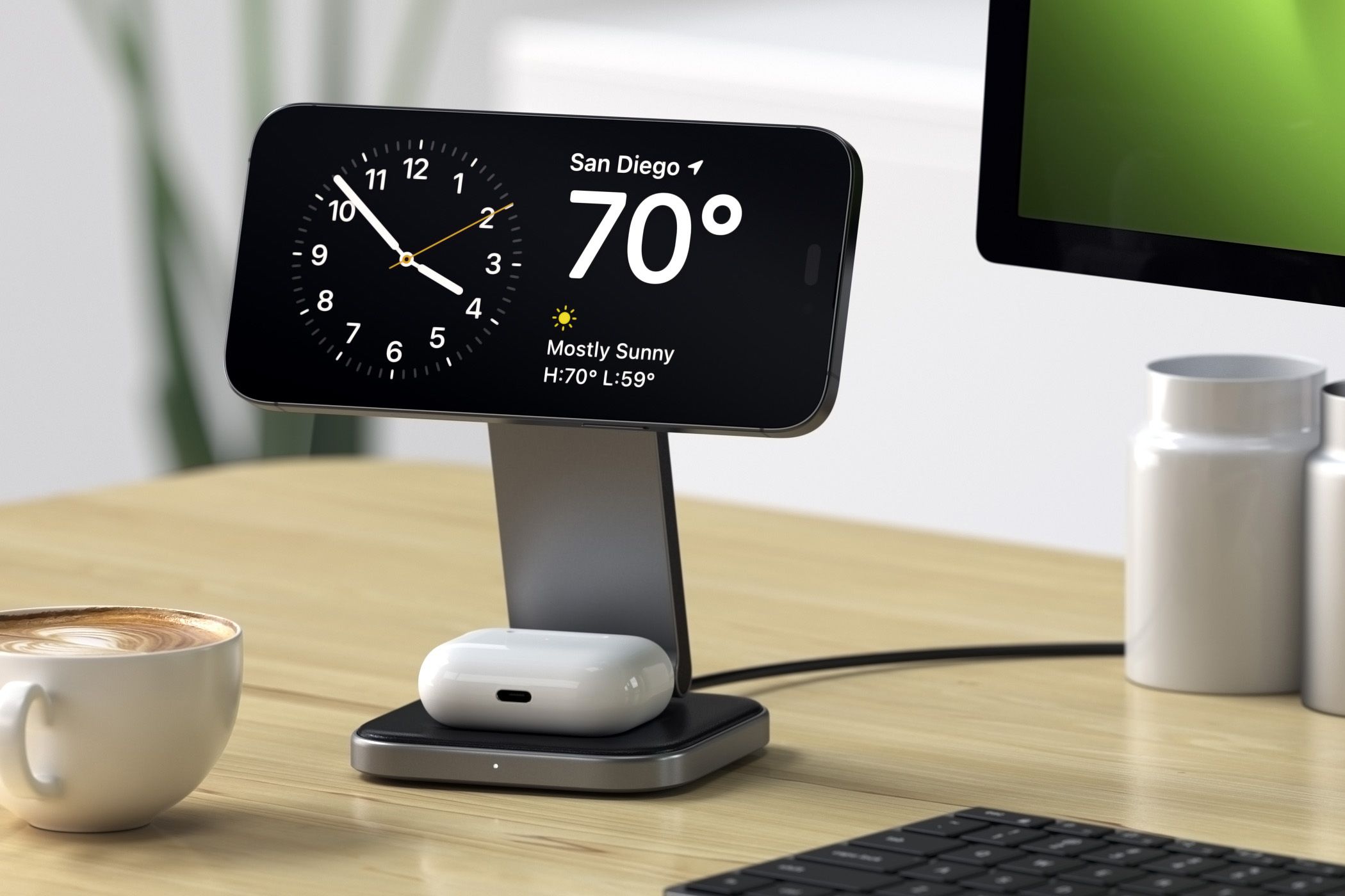 Charging stand on a desk holding an iPhone and an AirPods case