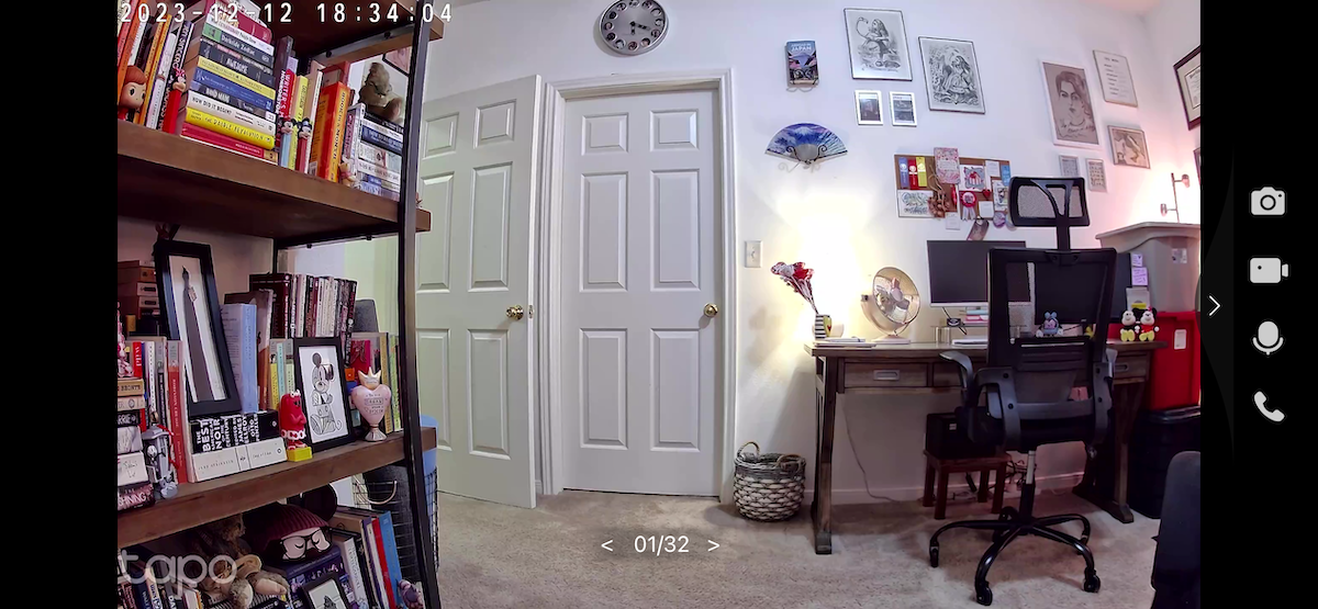 The TP-Link Tapo C120 capturing daytime footage in an office with lamps and an overhead fixture