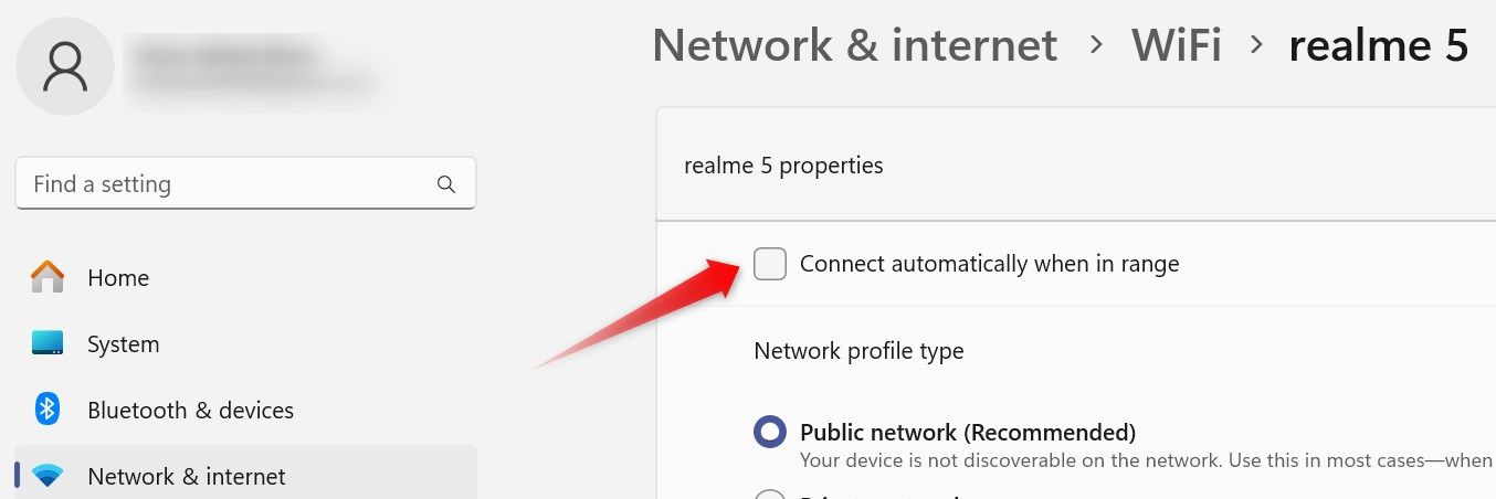 Unchecking the 'connect automatically when in range' option in the Windows Settings app.
