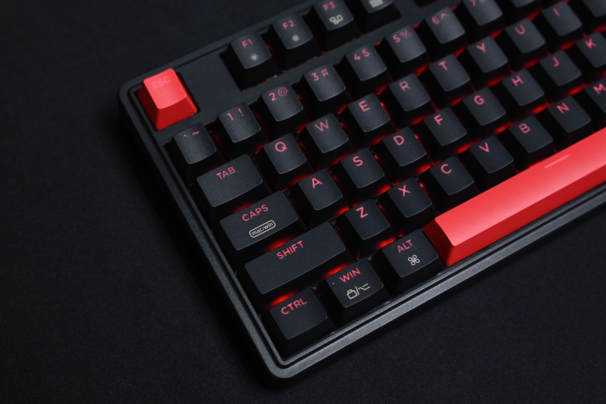 A keyboard with red Escape button and a red Spacebar. 