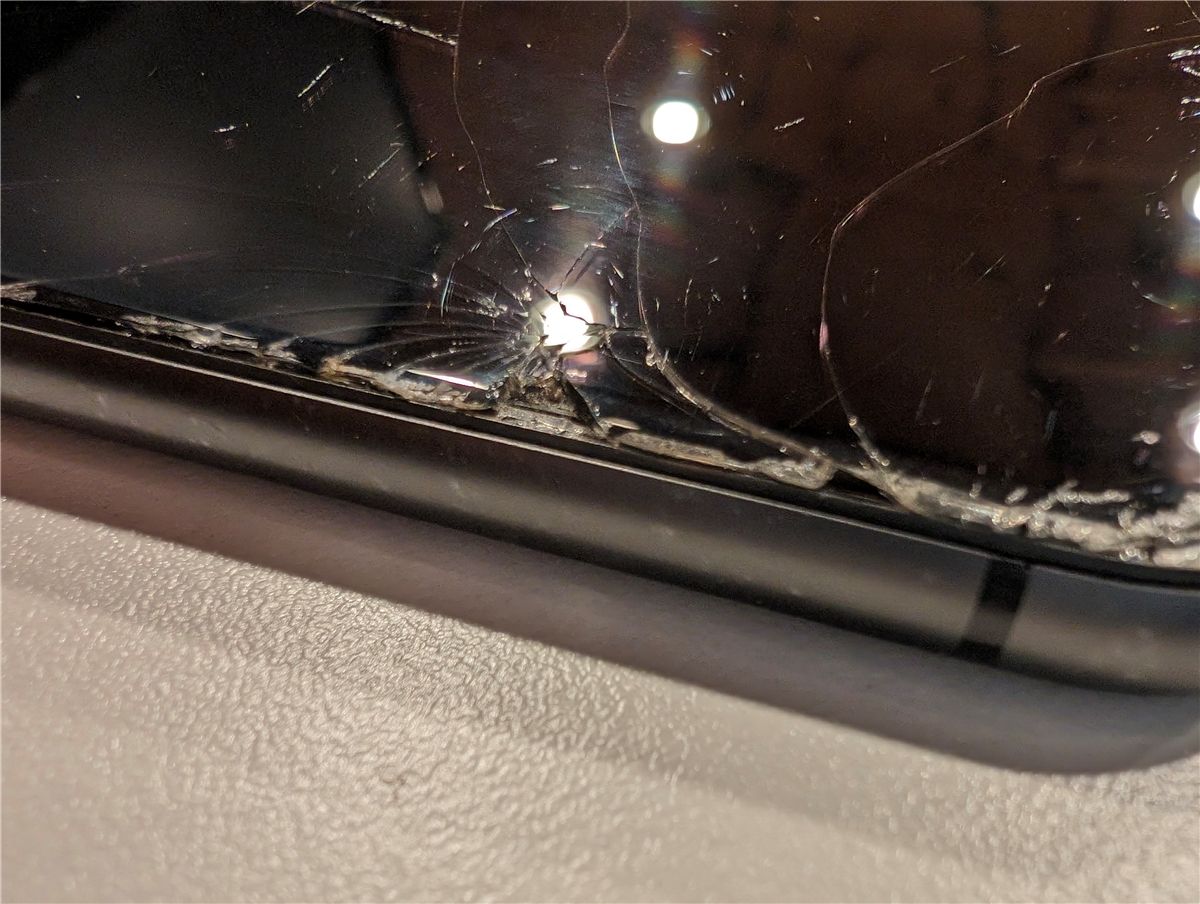 An iPhone with a badly cracked screen. 