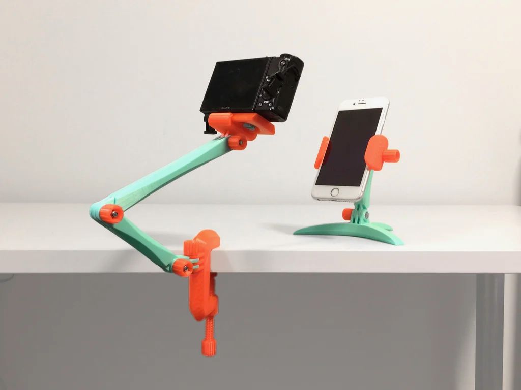 Pair of 3D printed mounts stands for electronics, one with an adjustable arm, holding a camera, the other with a fixed position, holding a phone
