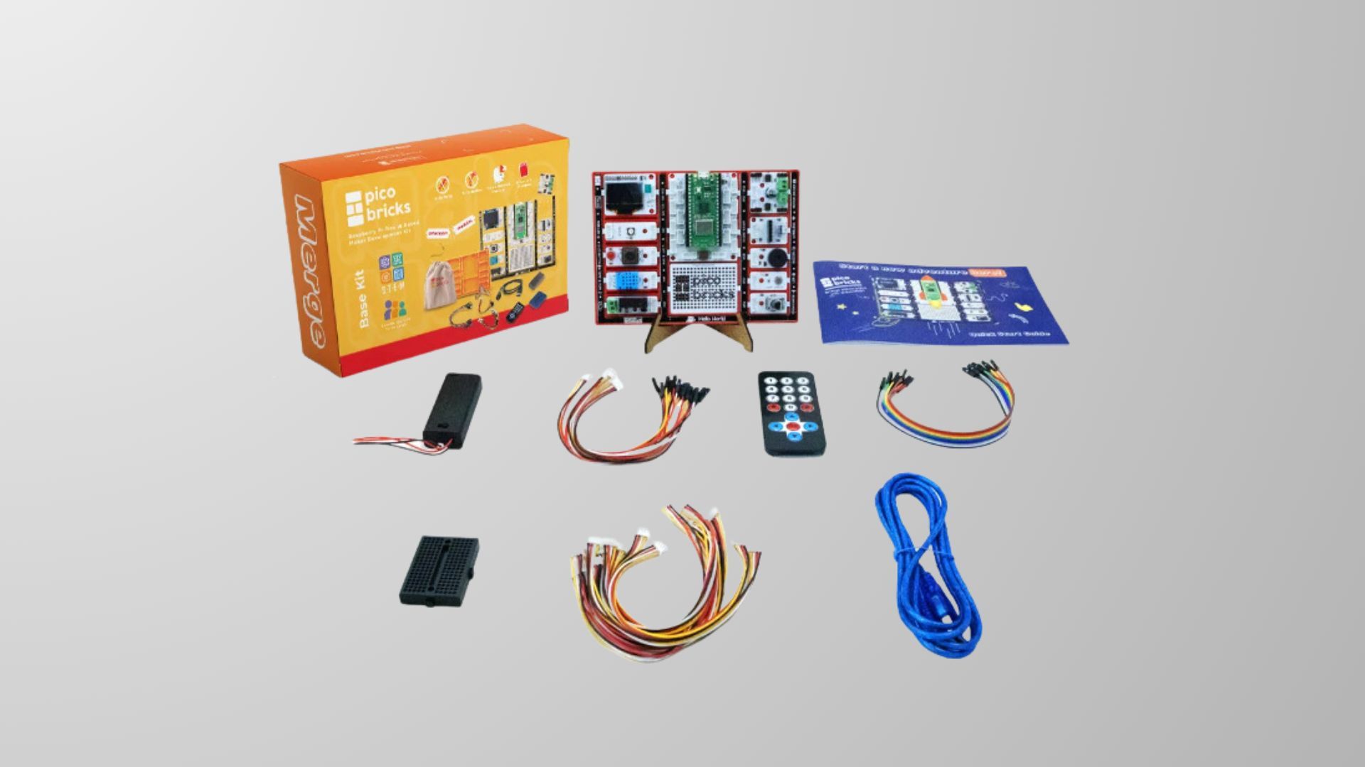 Raspberry Pi PicoBricks Base Kit with wiring and remote against grey backdrop
