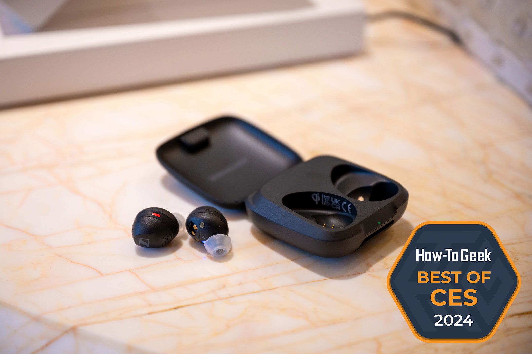 Sennheiser Momentum Sport earbuds sitting outside of their charging case at CES 2024