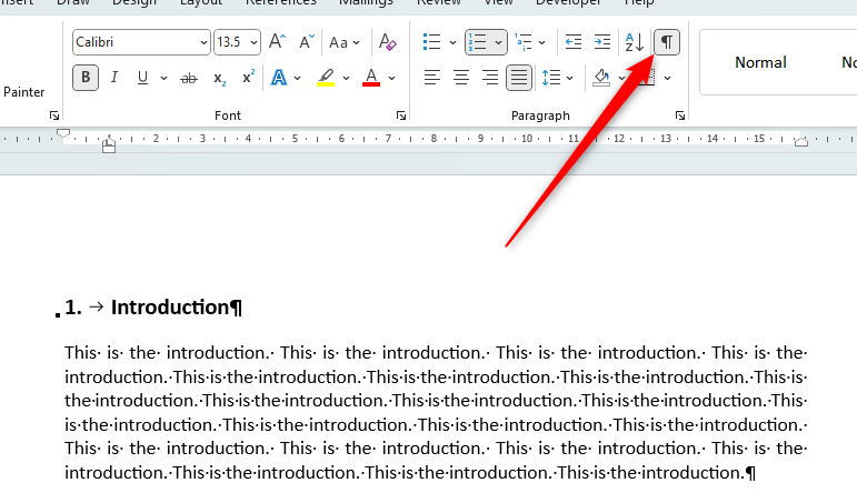 Word document highlighting where the Show/Hide icon is in the 'Paragraph' group.