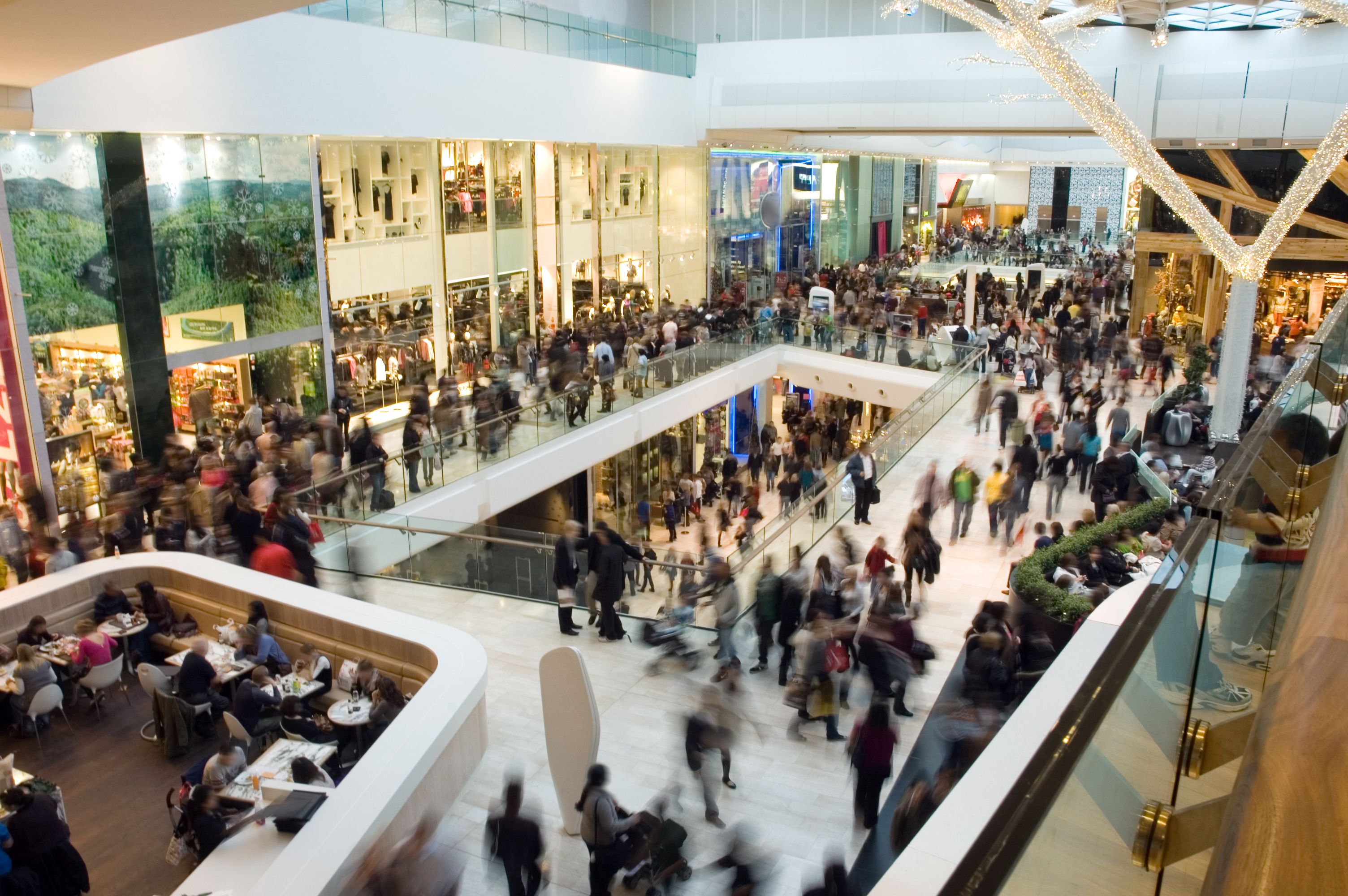 Lots of people in a crowded shopping mall.