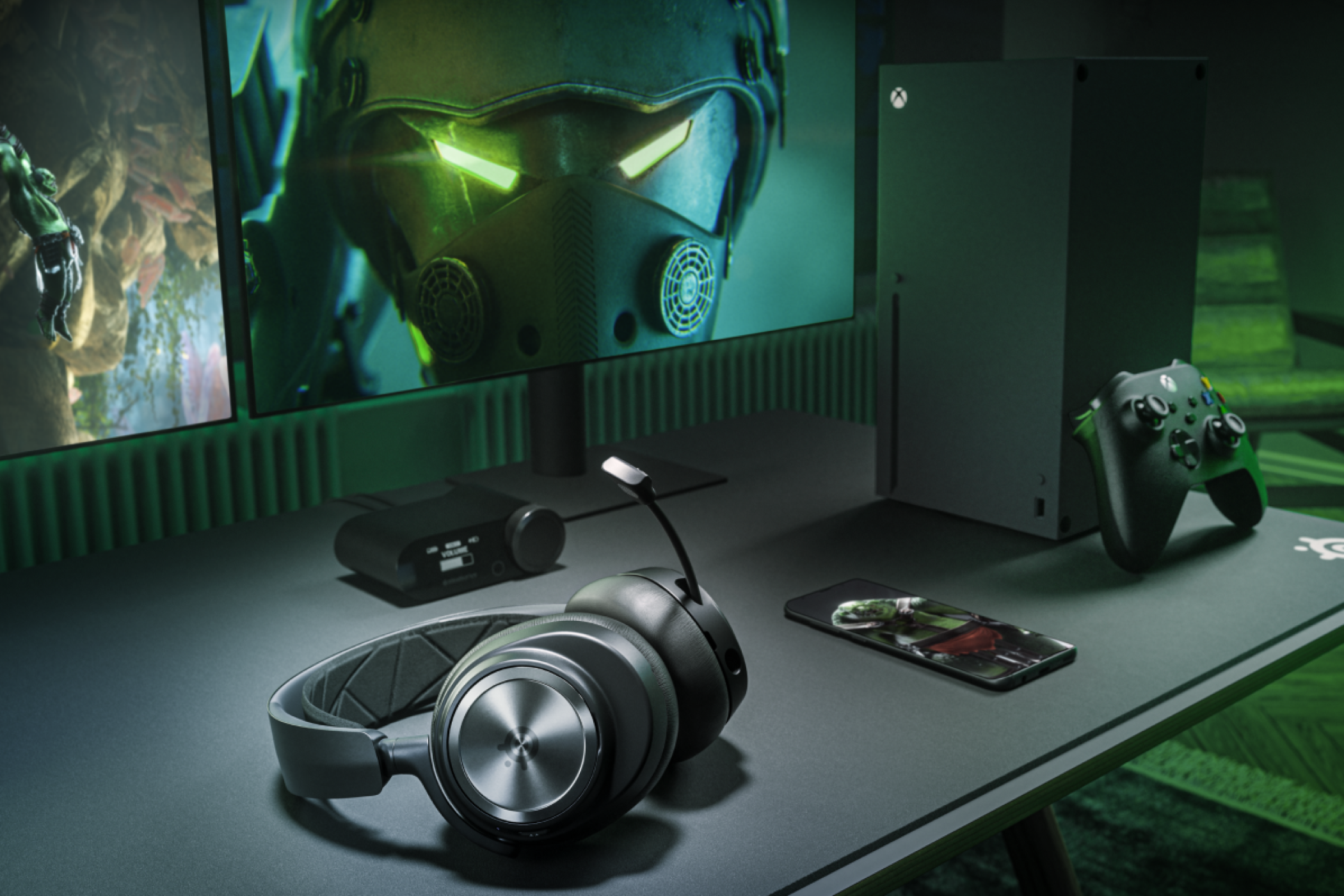 SteelSeries Arctis Nova Pro Wireless Xbox headset resting on a table next to an Xbox Series X console