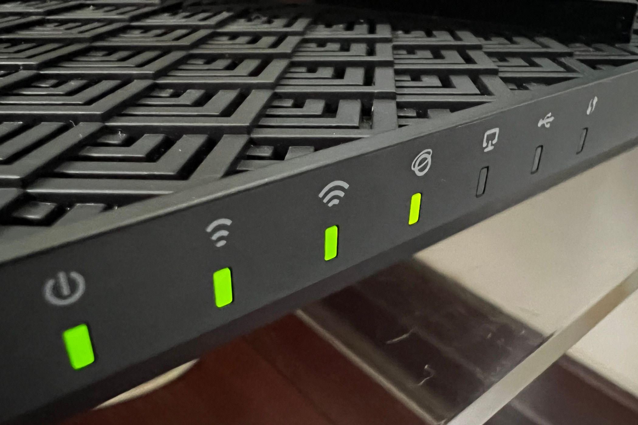TP Link AX72 router with four green lights.
