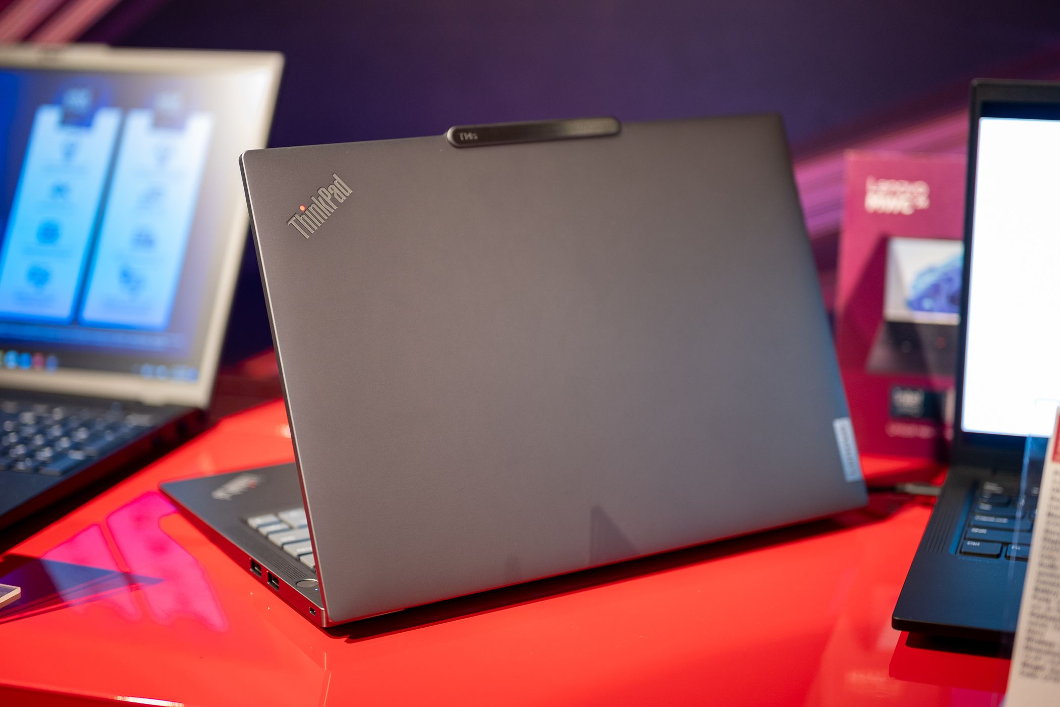 Back side of a Lenovo laptop with the ThinkPad logo visible.