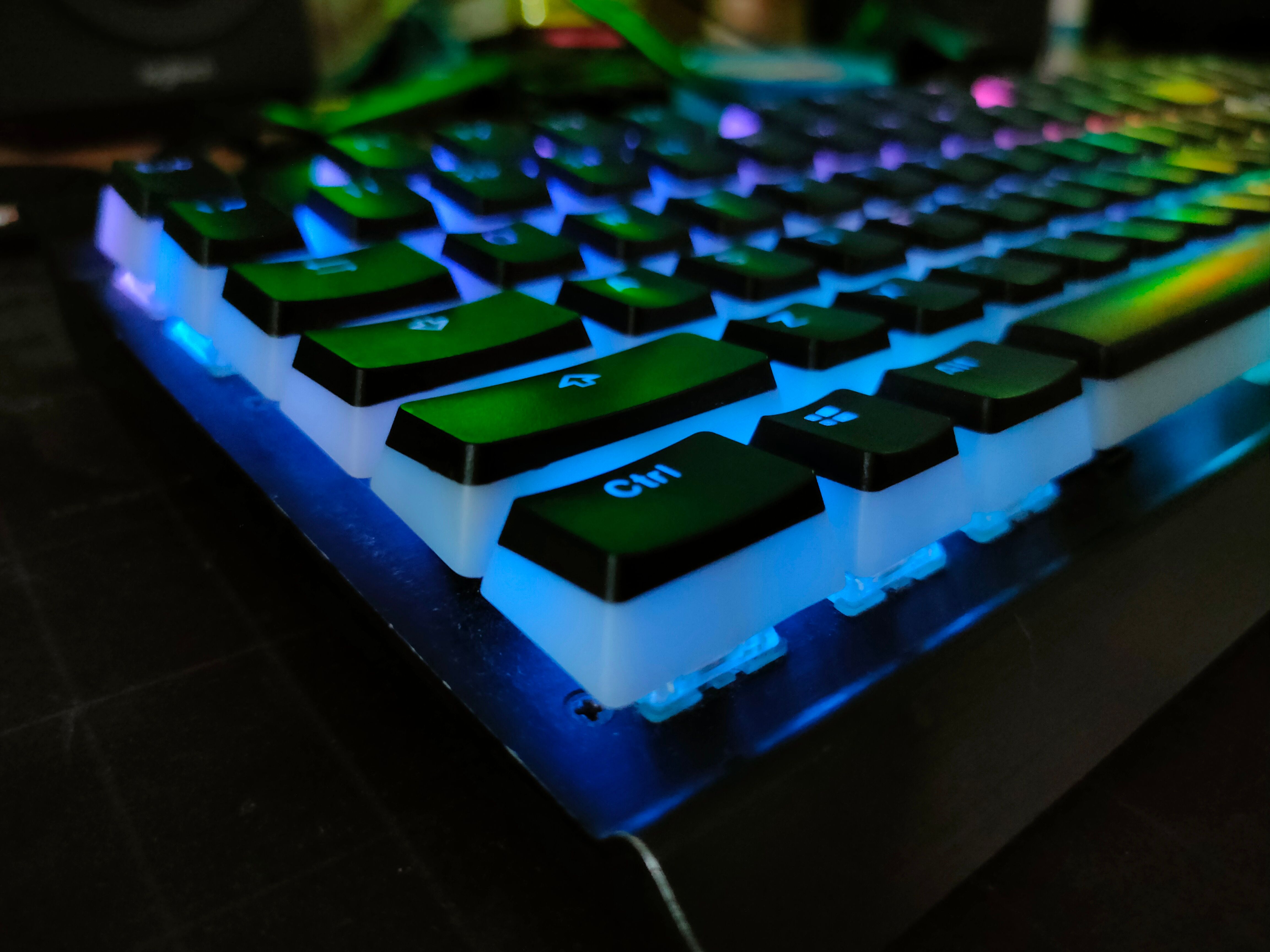 A Corsair K70 keyboard in the dark with pudding keycaps and RGB lights.