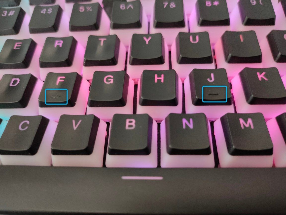 A close-up shot of an RGB keyboard with the ridges on F and J keys in focus.