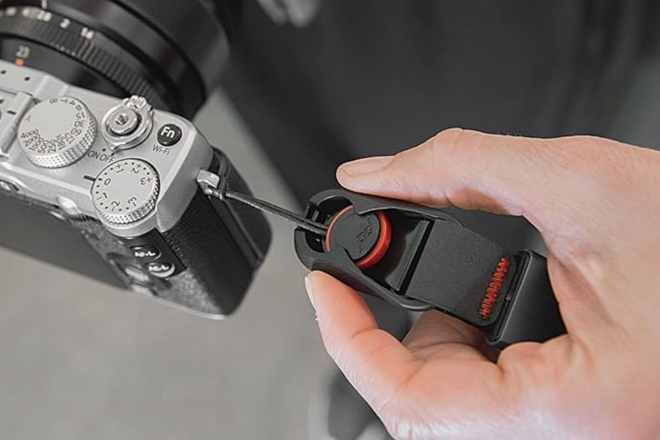 The anchor threaded to a camera and attached to the Peak Design Cuff Camera Wrist Strap