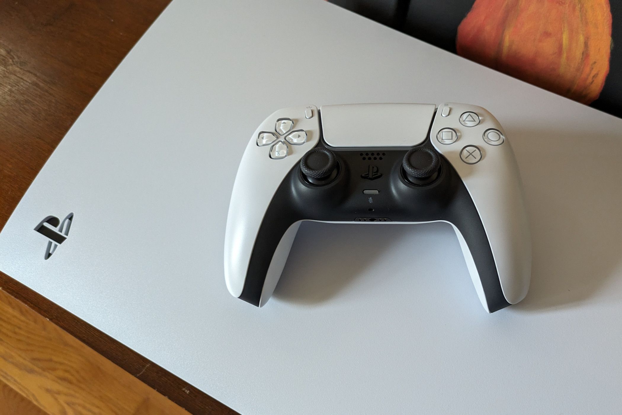 Sony PlayStation 5 DualSense controller on top of a console.