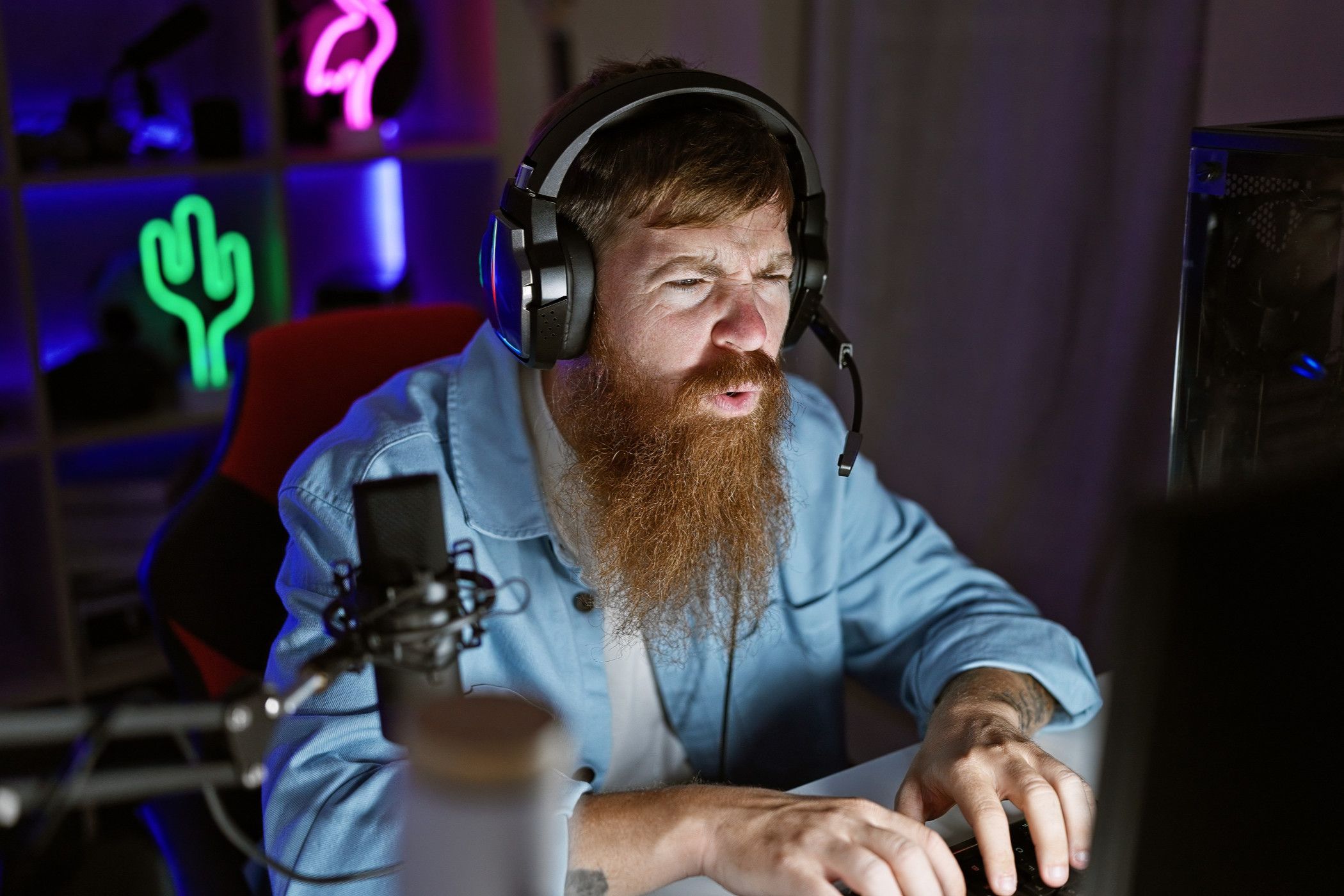 A concerned looking bearded gamer peering at the screen.