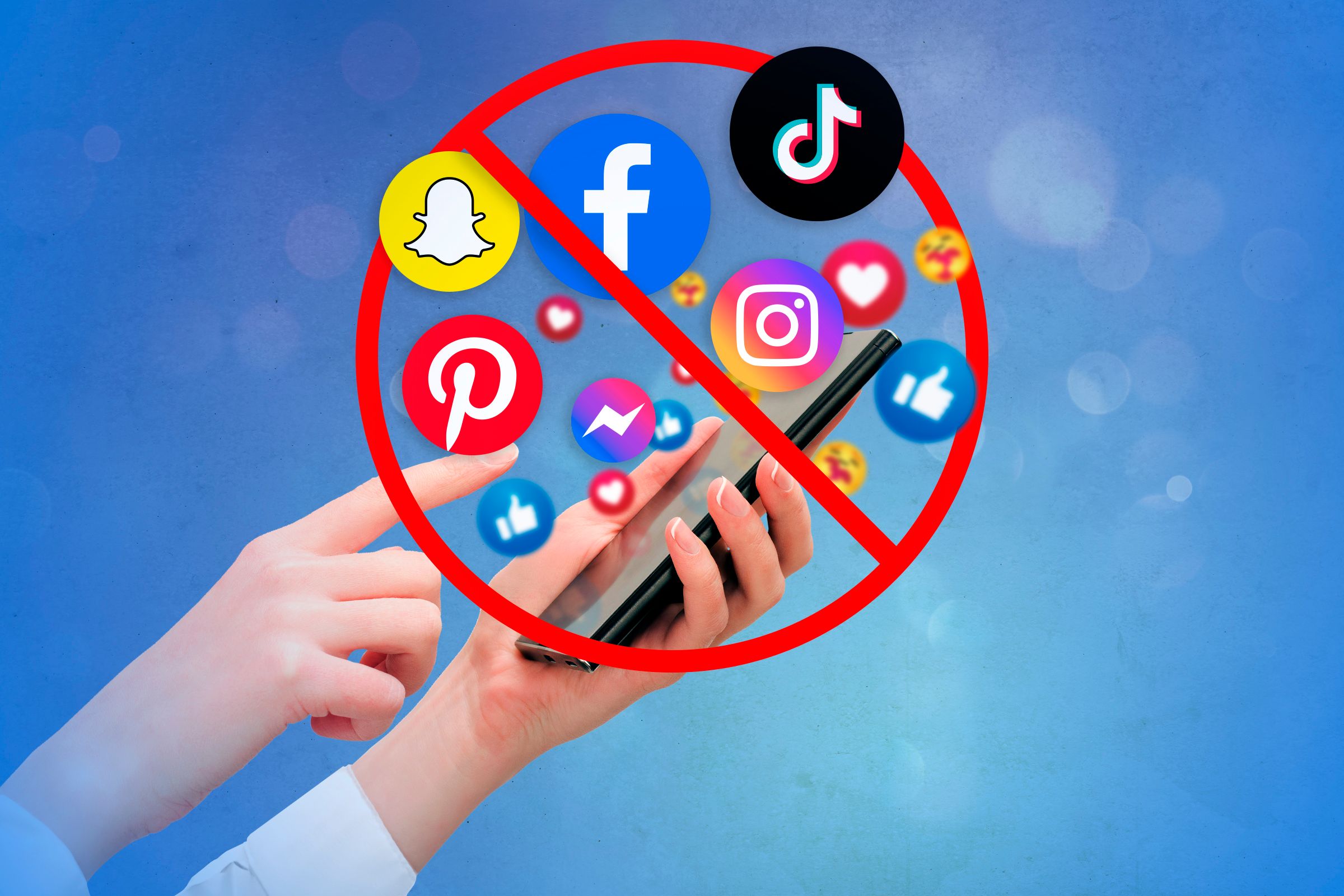 A hand holding a smartphone and a lot of emojis and social media symbols coming out of the smartphone with a prohibited symbol in front of them
