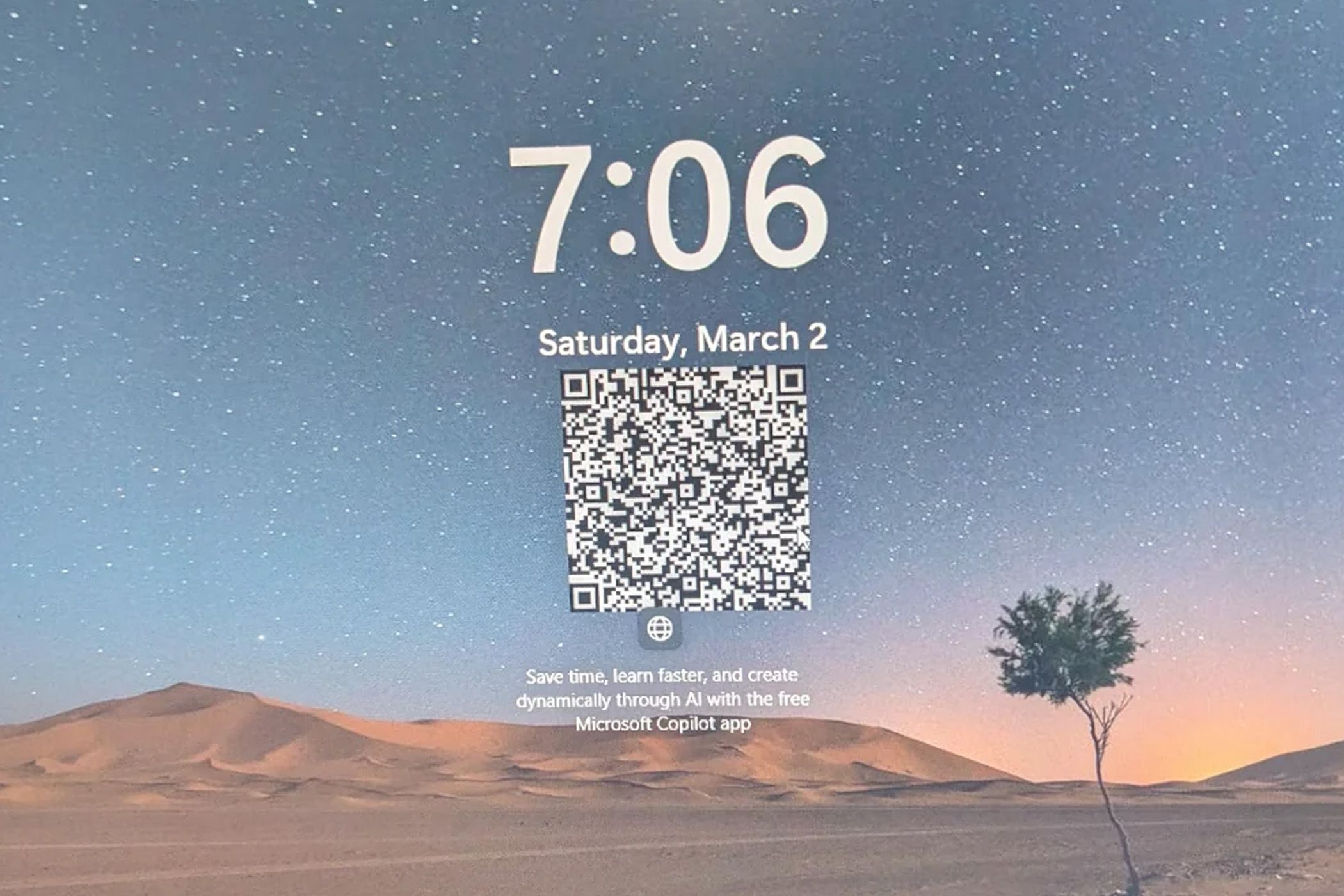 Desert landscape wallpaper with clock overlay and QR code on a computer screen.