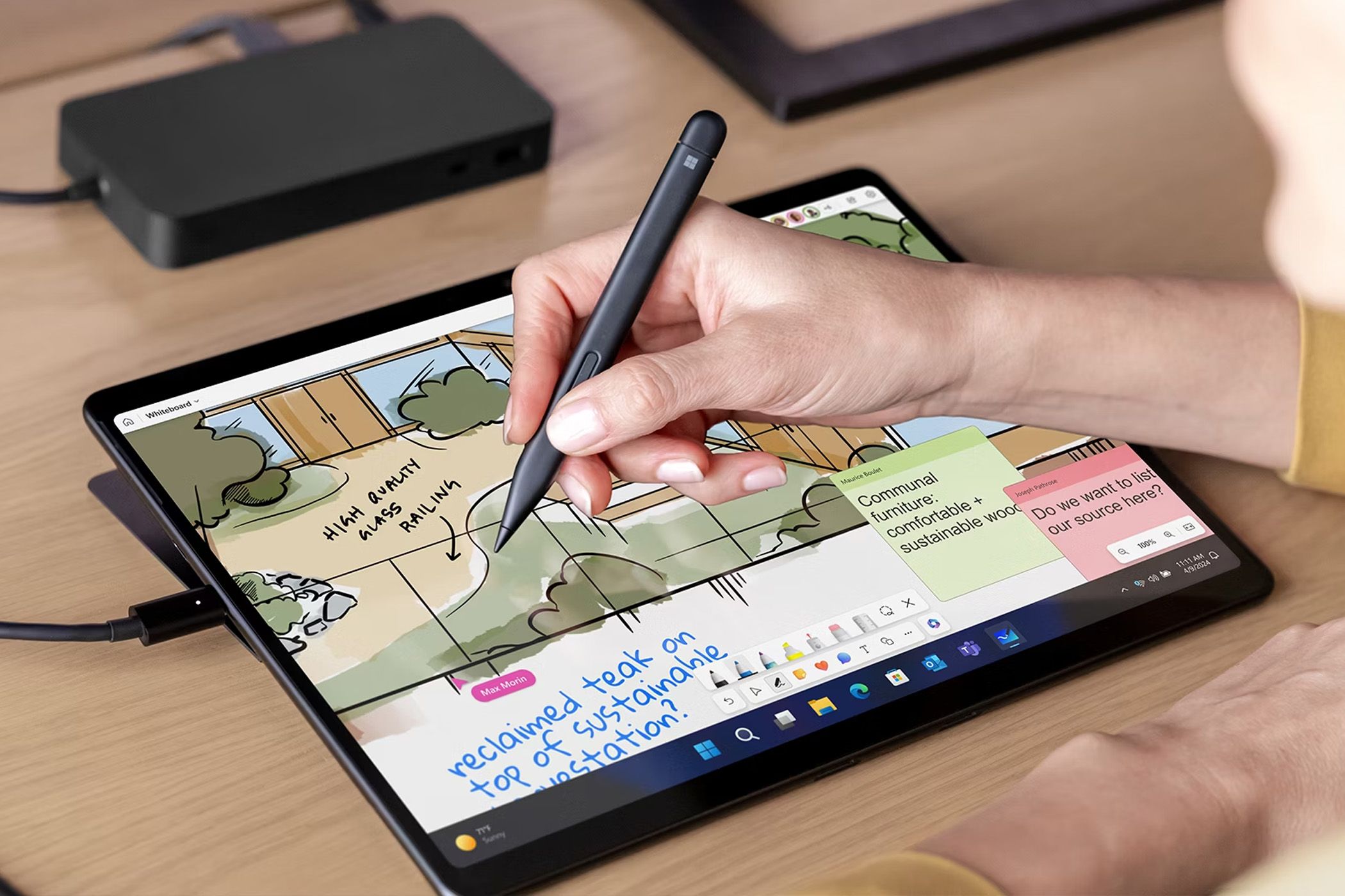 Person drawing on a tablet with a stylus.