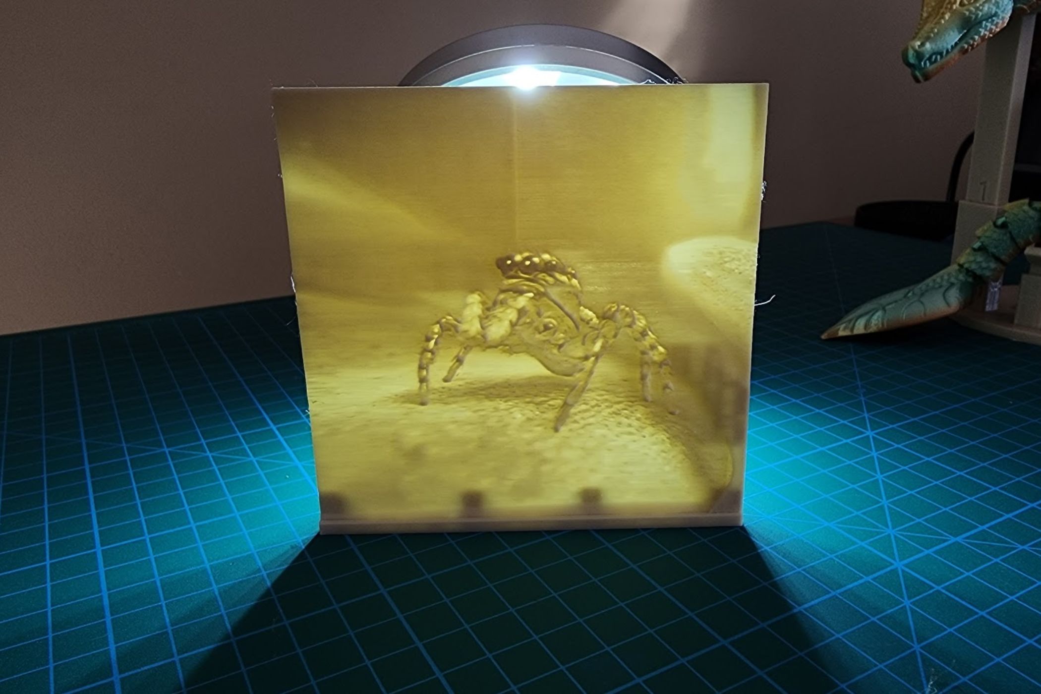 A 3D-printed lithophane of a jumping spider sitting on a plant