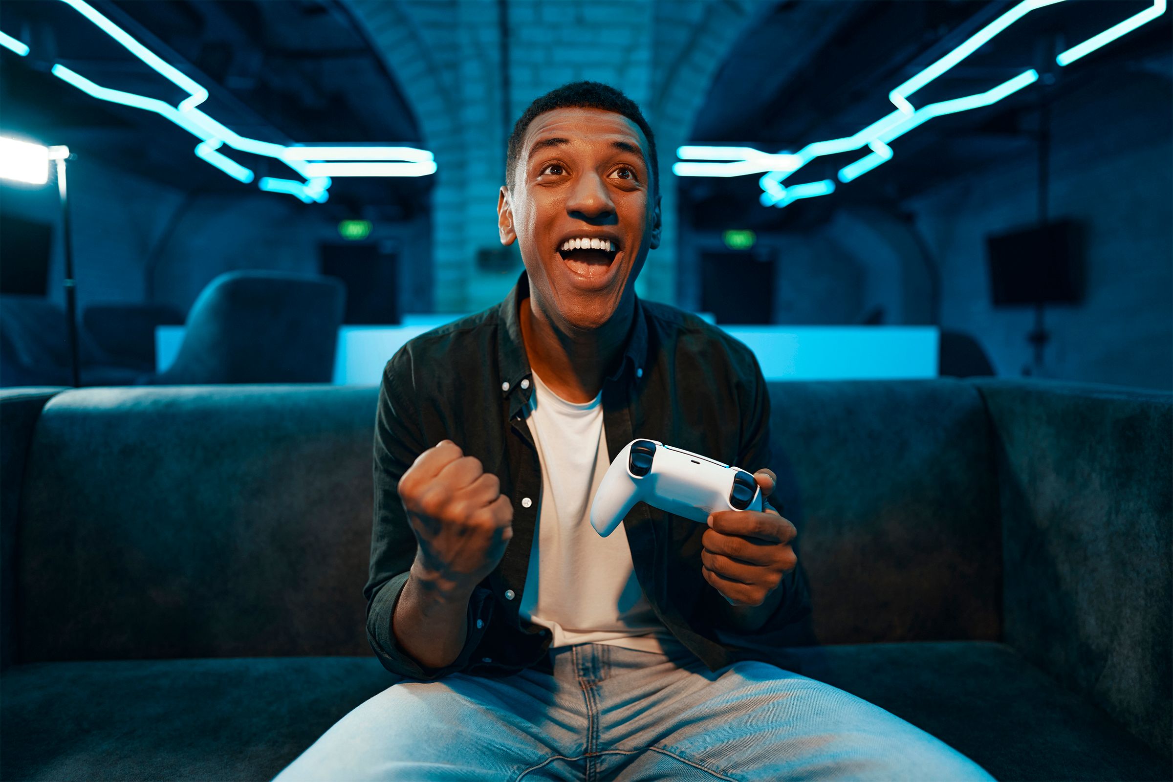 A happy man holding a video game controller.