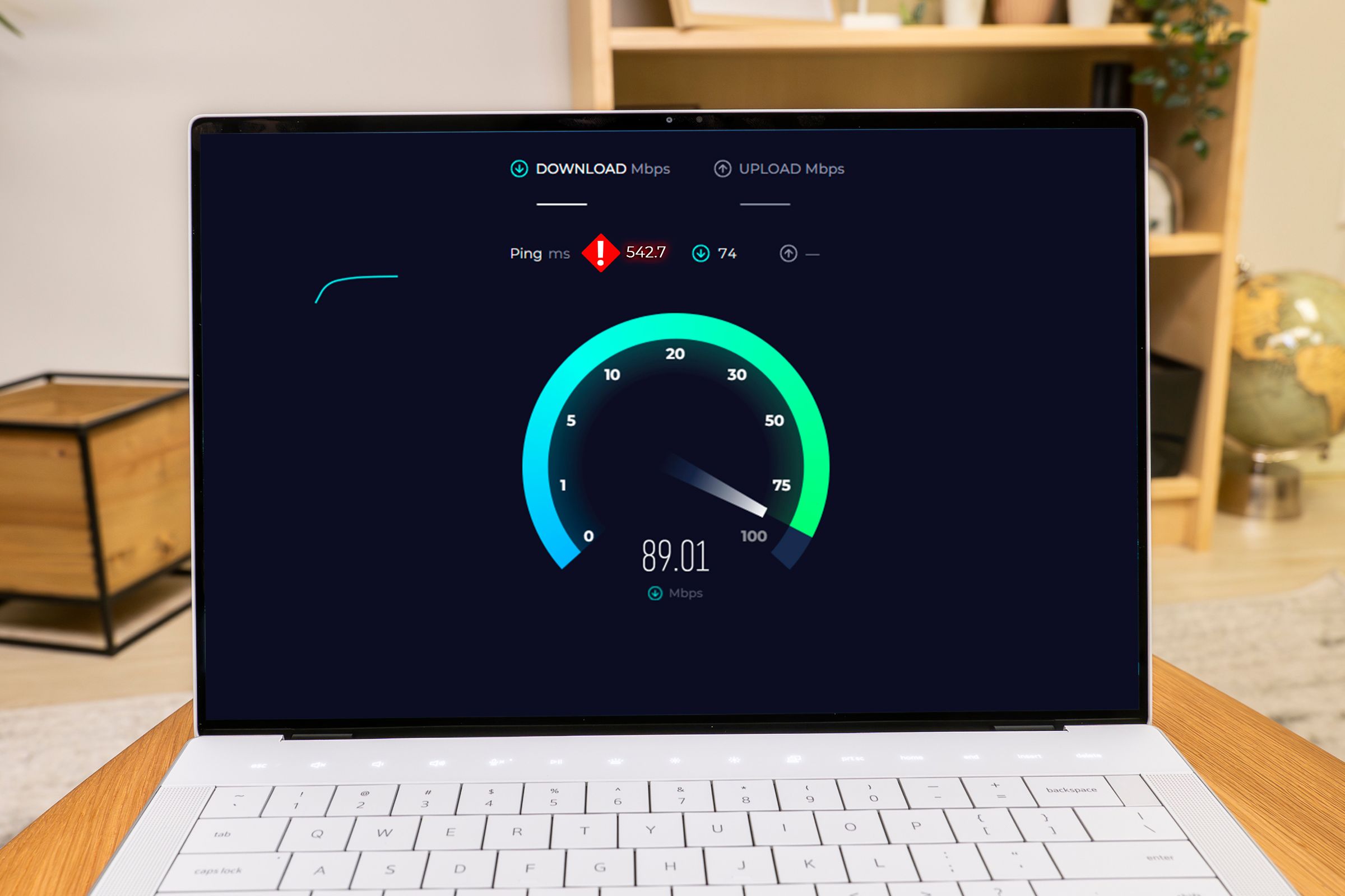 A laptop running a network speed test and displaying a high ping.