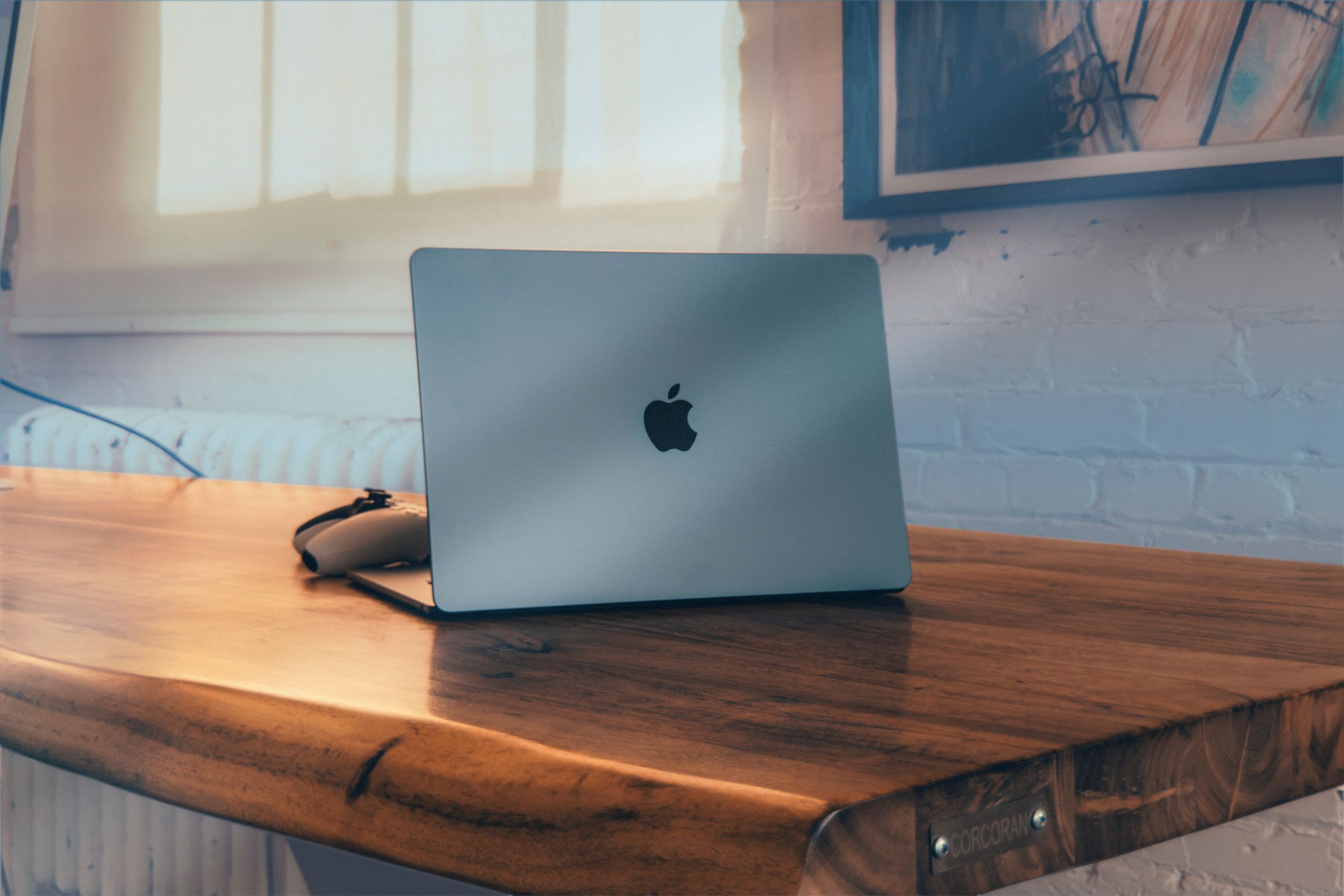 A MacBook air on a wooden table. 