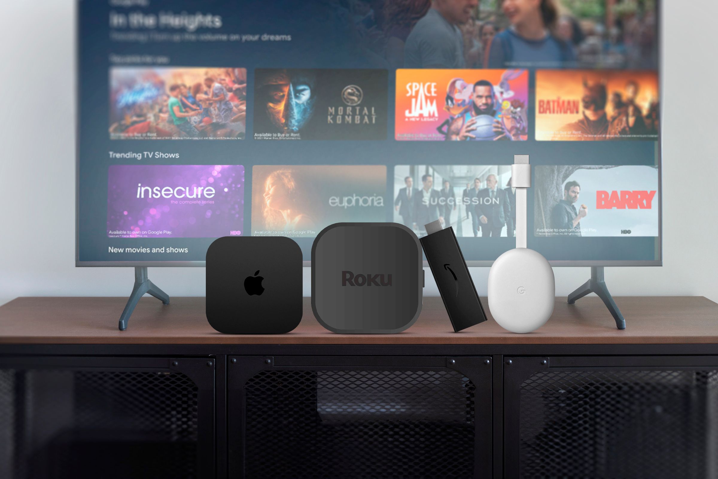 An Android TV with an Apple TV, Roku, Amazon Fire TV, and Chromecast positioned in front