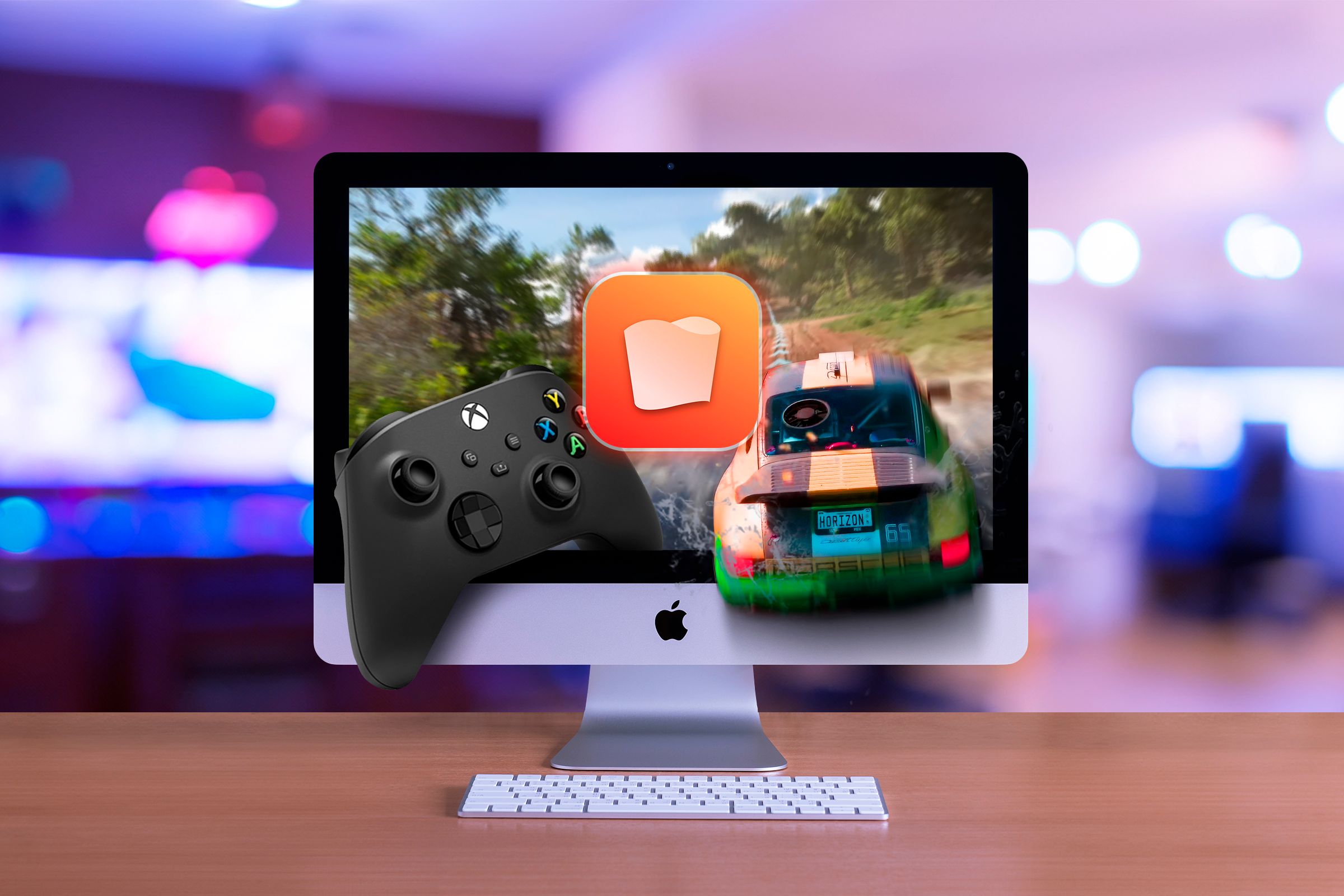 An iMac running a game with an Xbox controller on the left and the Whisky app logo in the center of the screen.