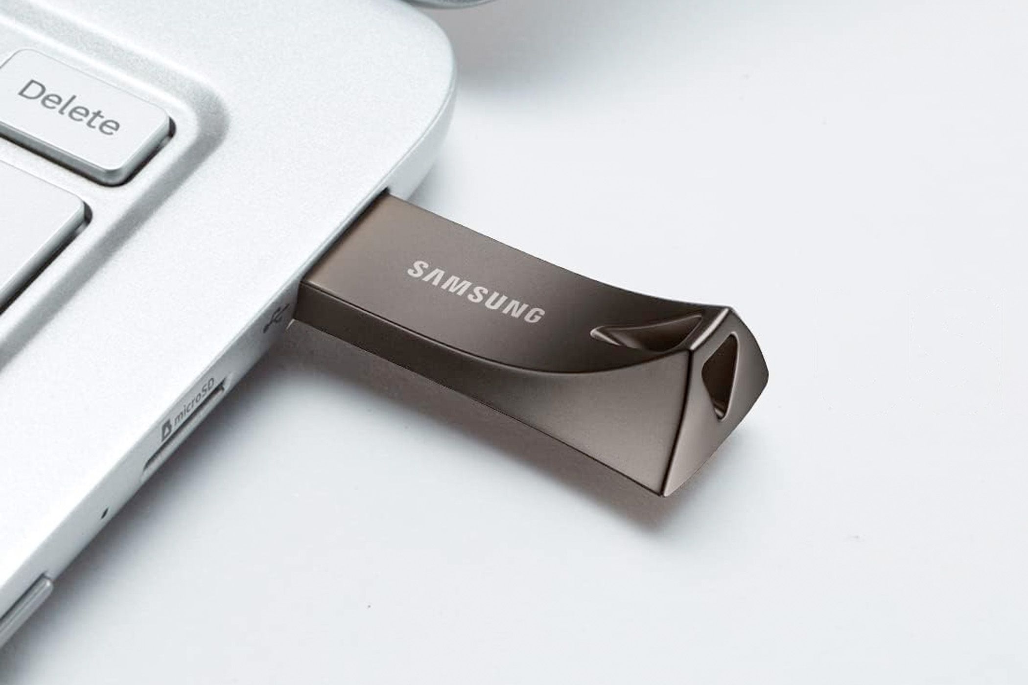 Photo of a Samsung flash drive plugged into a laptop.