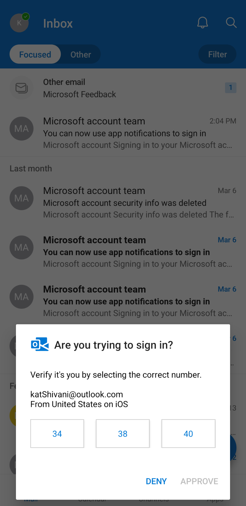 Phone screen displaying a Microsoft sign-in notification with a verification request.