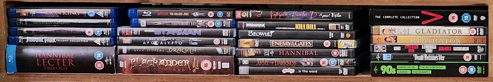 A small movie collection comprised of DVDs and Blu Ray discs.