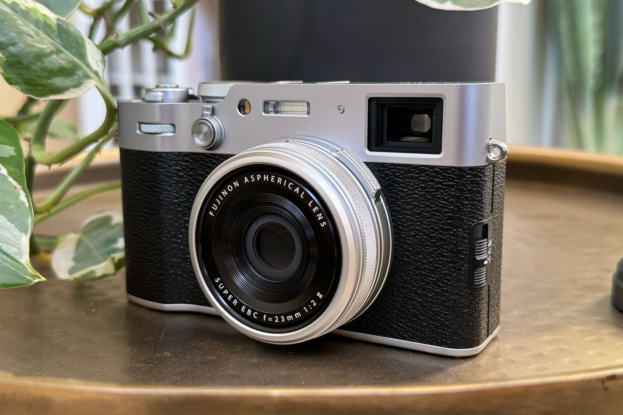 Fujifilm X100VI sitting on a table with the lens cover off