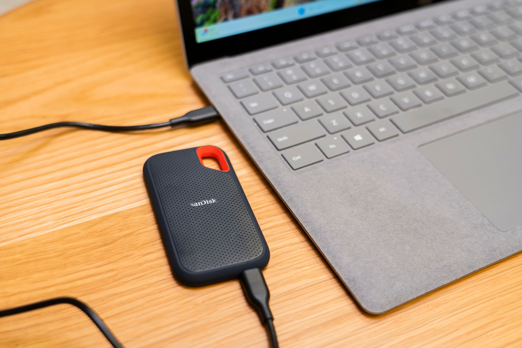 An external SSD connected to a laptop.