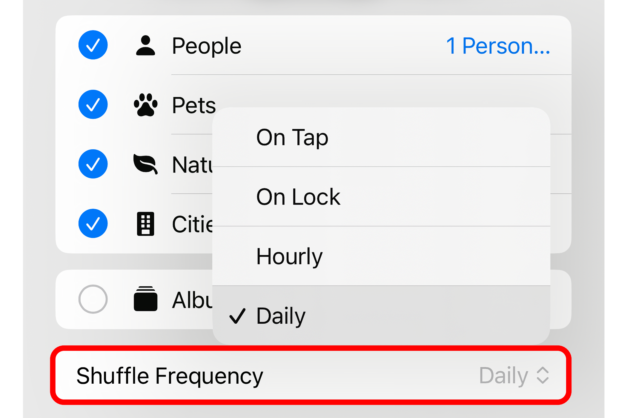 Choosing daily shuffle frequency for a photo shuffle wallpaper on iPhone.