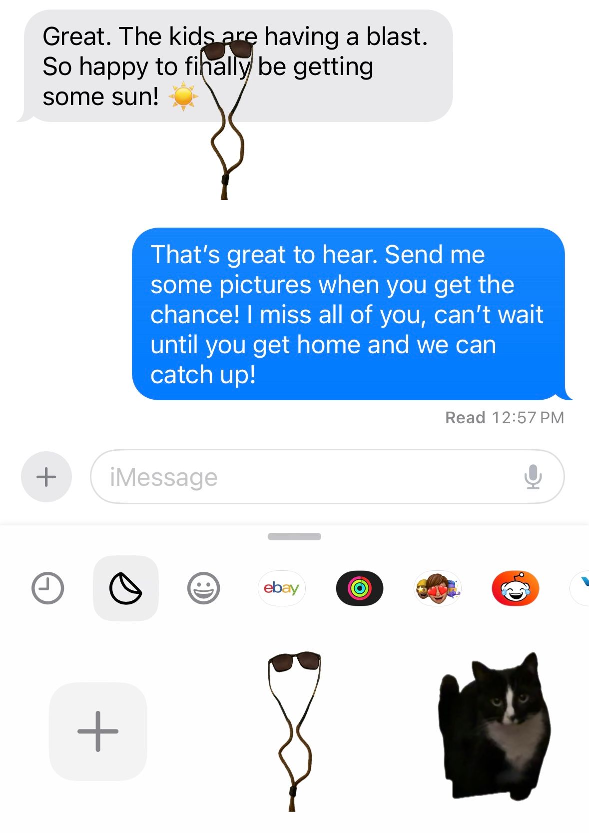 Sticker of sunglasses placed on top of a message in iMessage.