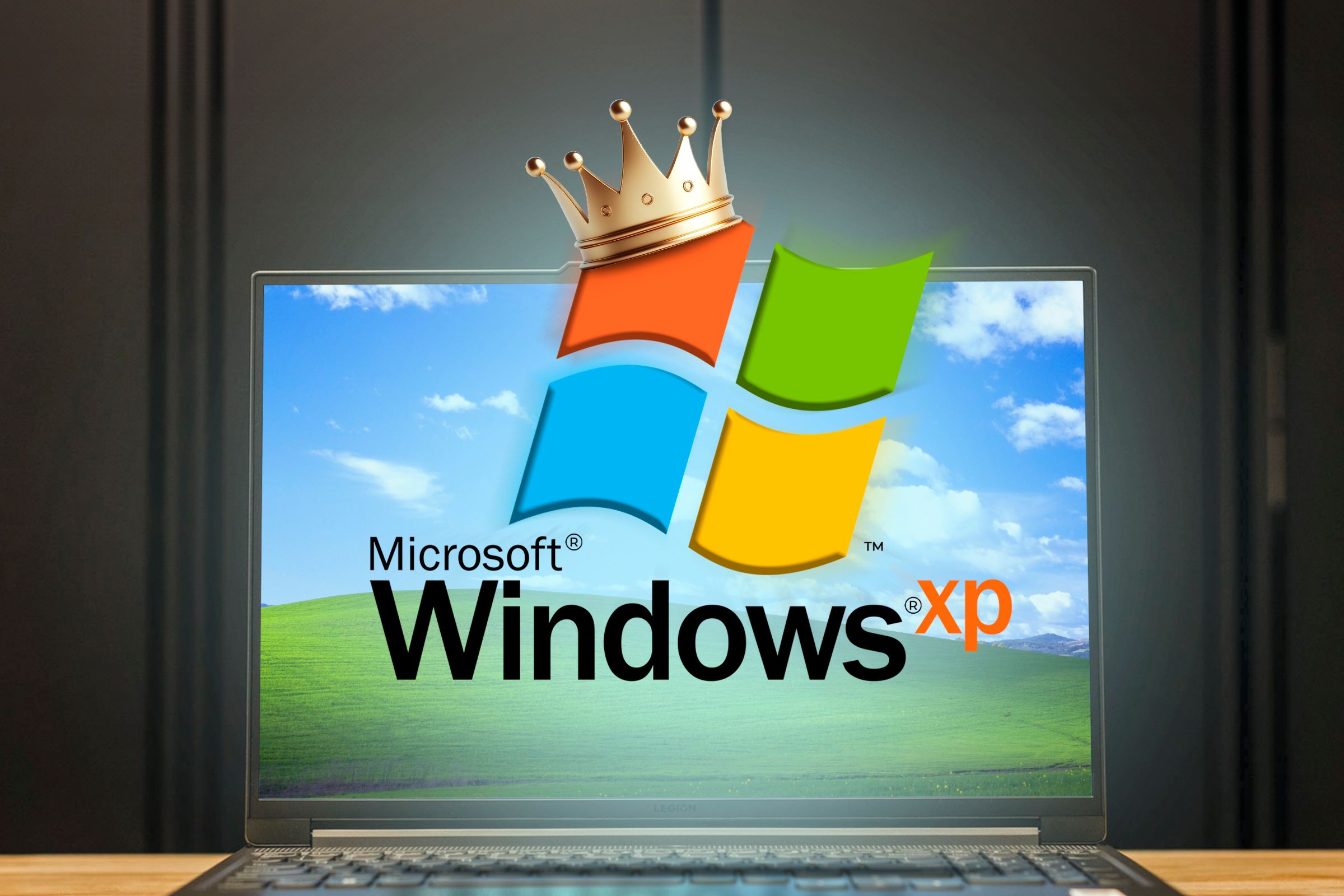 Laptop with the default Windows XP wallpaper and the Windows XP logo with a crown in the center.