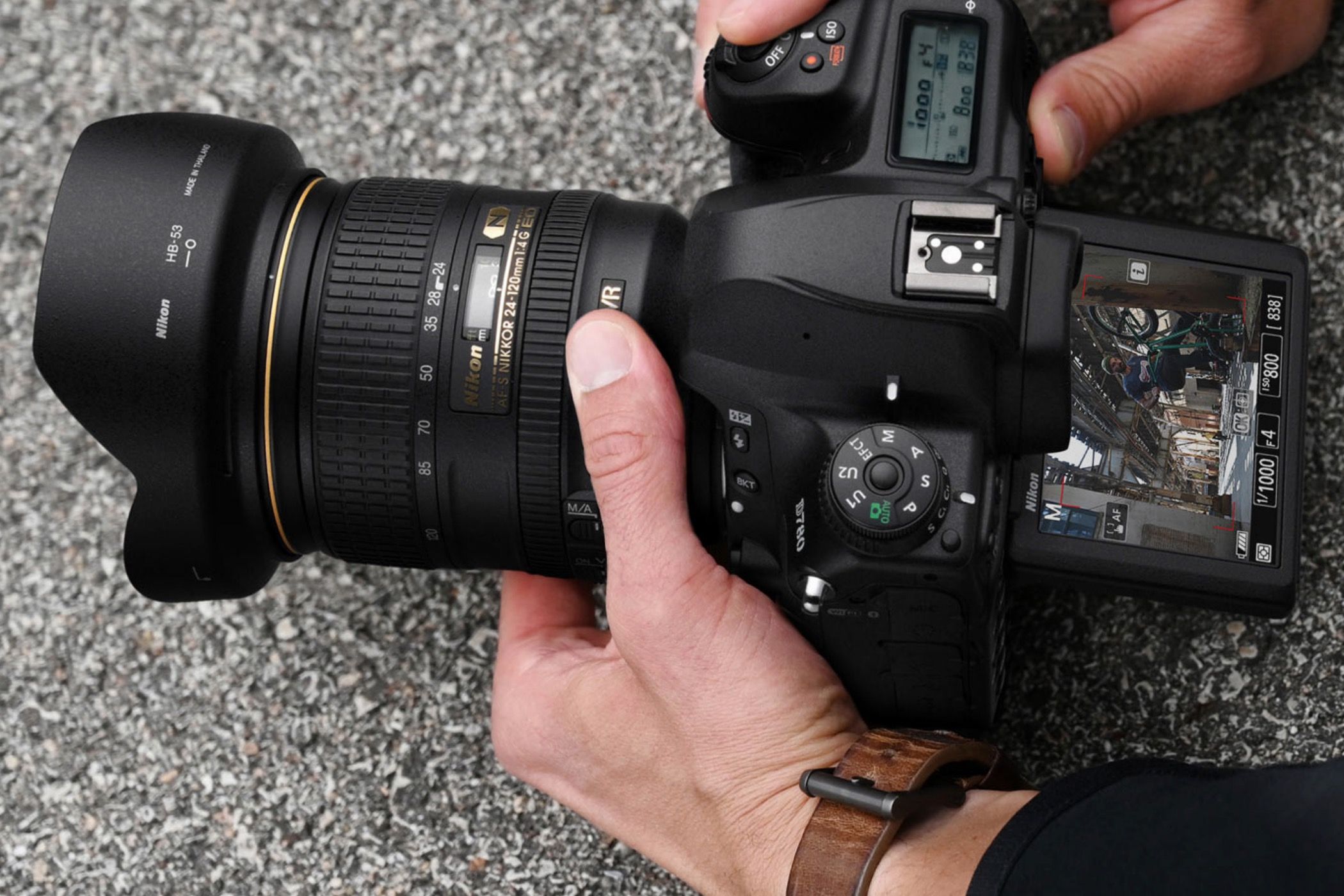 A man recording video on the Nikon D870.