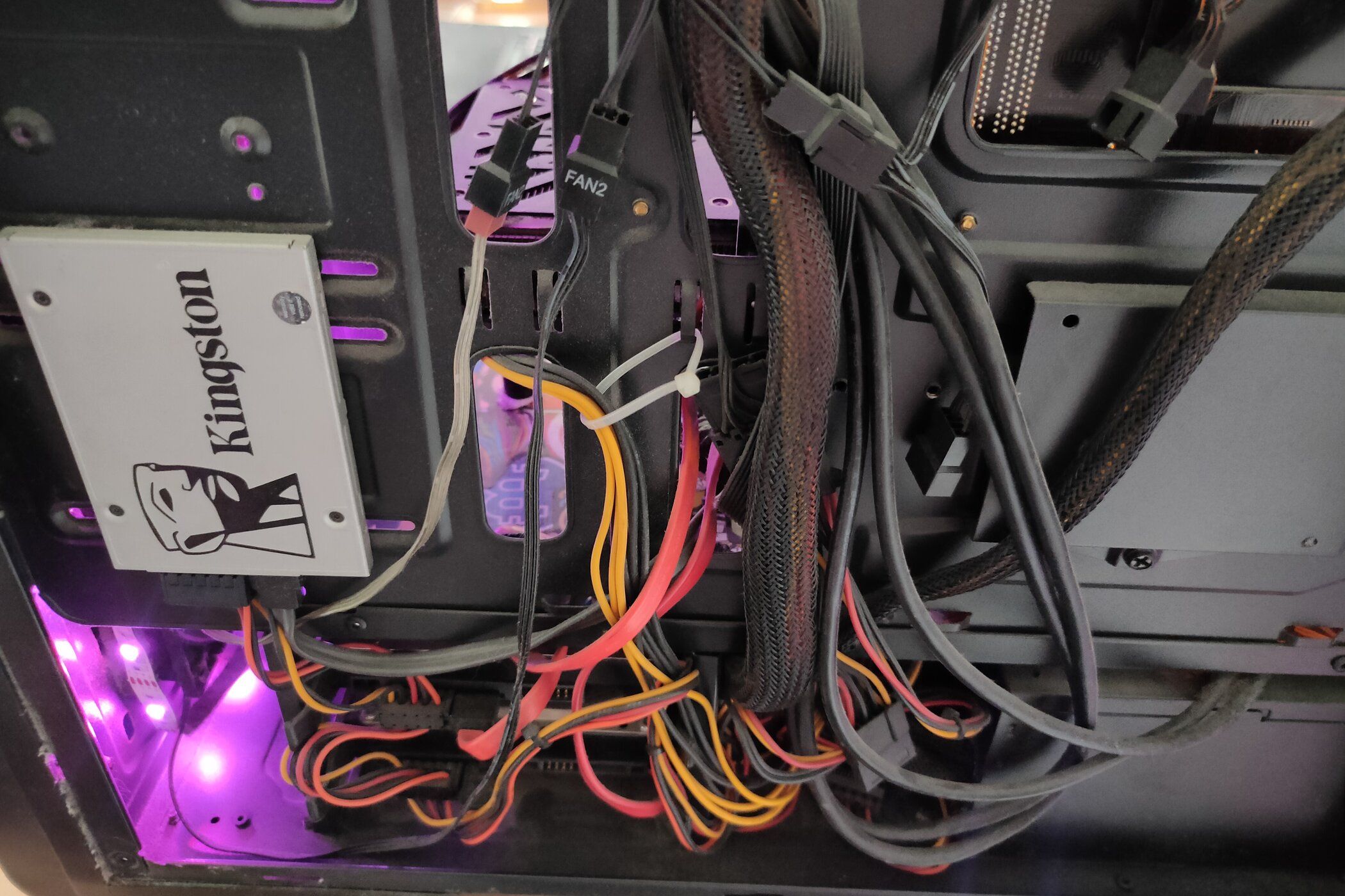 The inside of a PC with many colorful and messy cables.