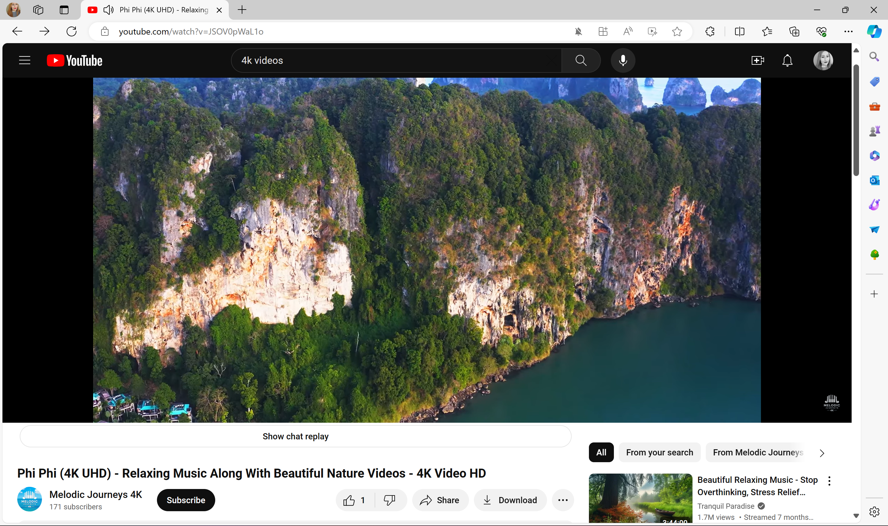 A screenshot of a YouTube video showing a lush cliffside in Thailand.