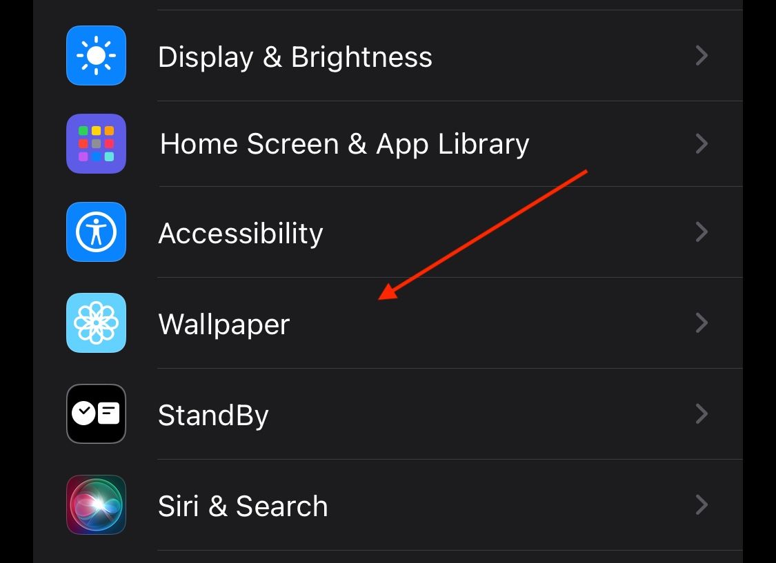 Accessing iOS wallpaper settings in the Settings app.