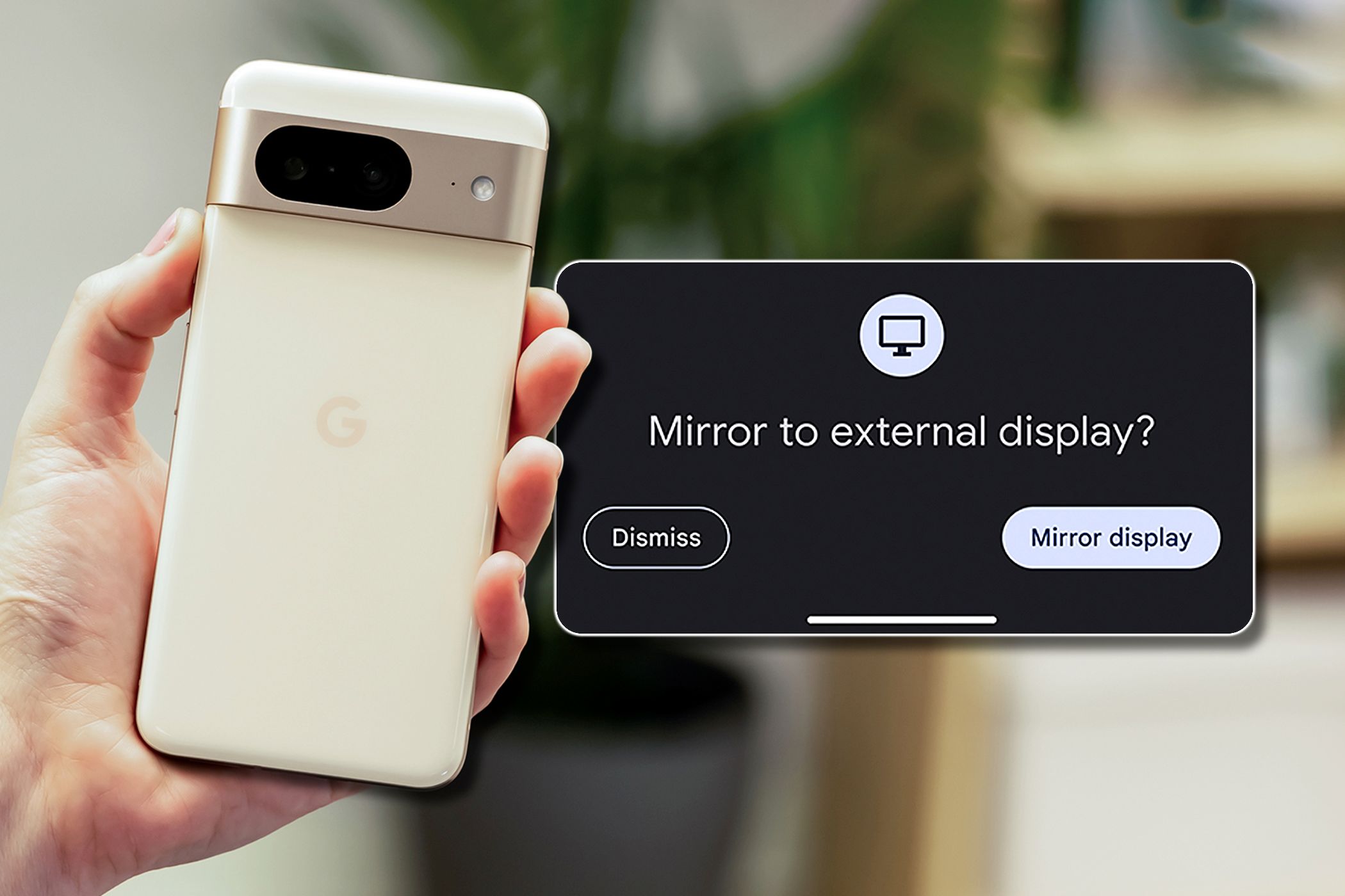 Someone holding a Pixel 7 smartphone with a prompt asking if the user wants to mirror to an external display.