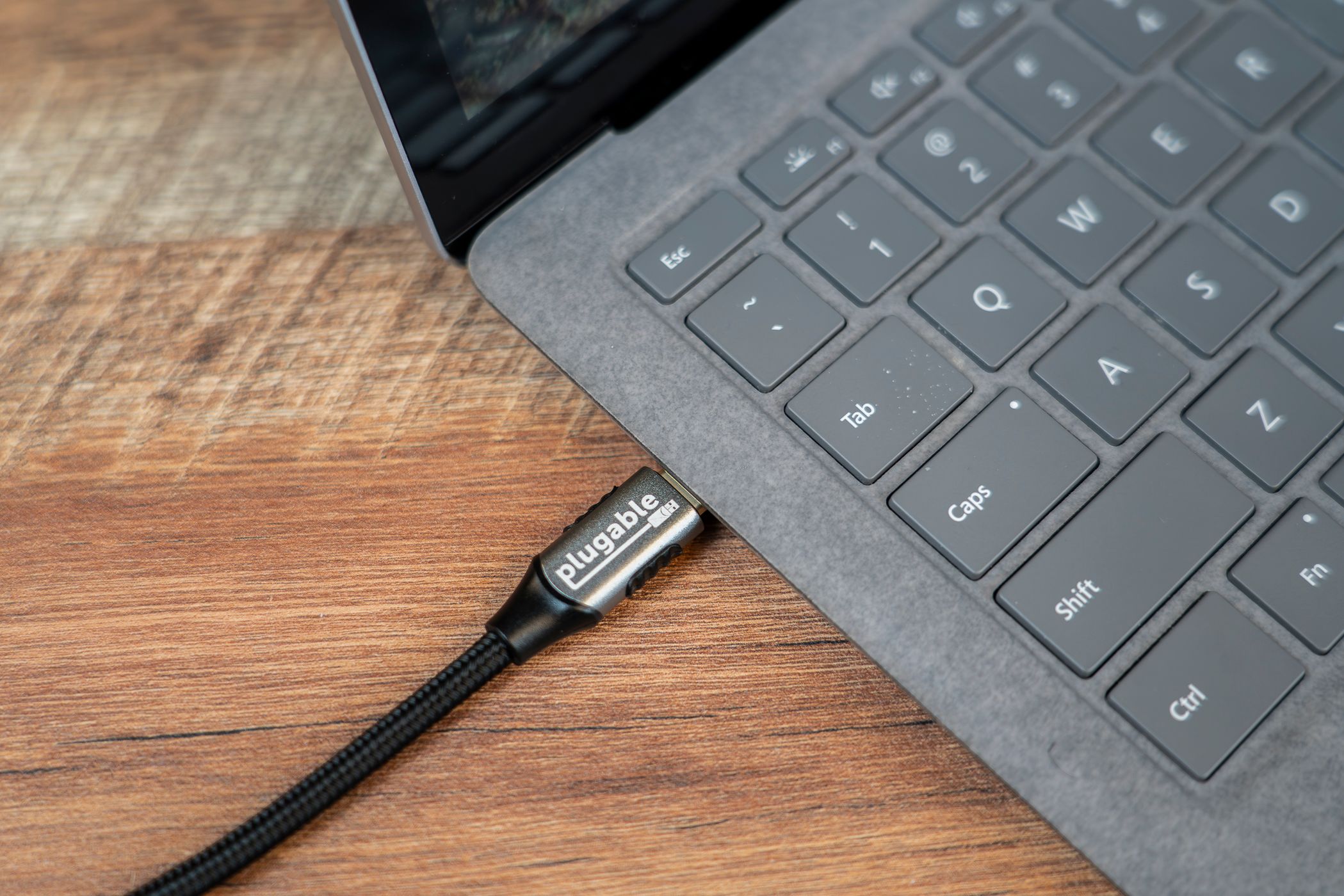 Plugable USB-C to HDMI 2.1 8K adapter connected to a laptop.