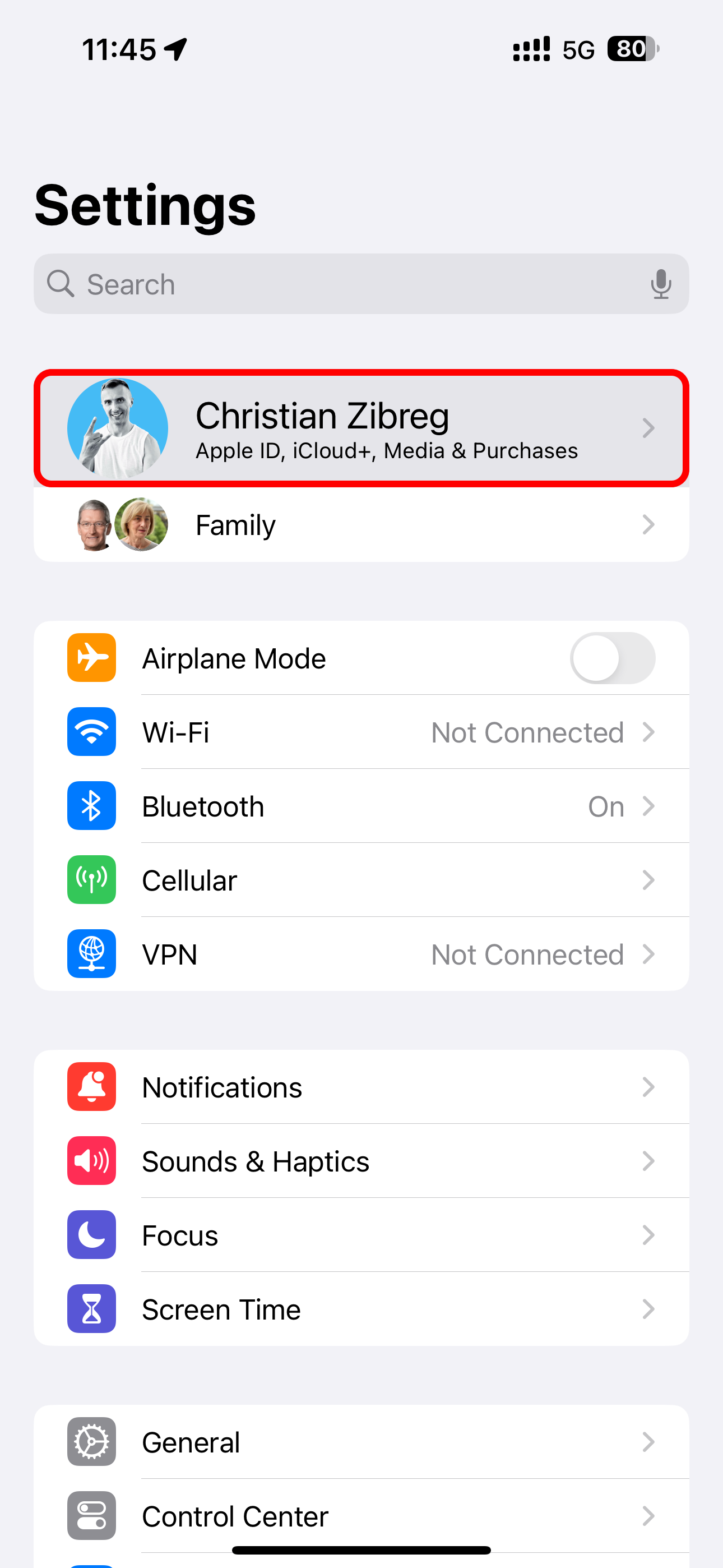 The Settings app on iPhone with a user's Apple ID profile name highlighted at the top.
