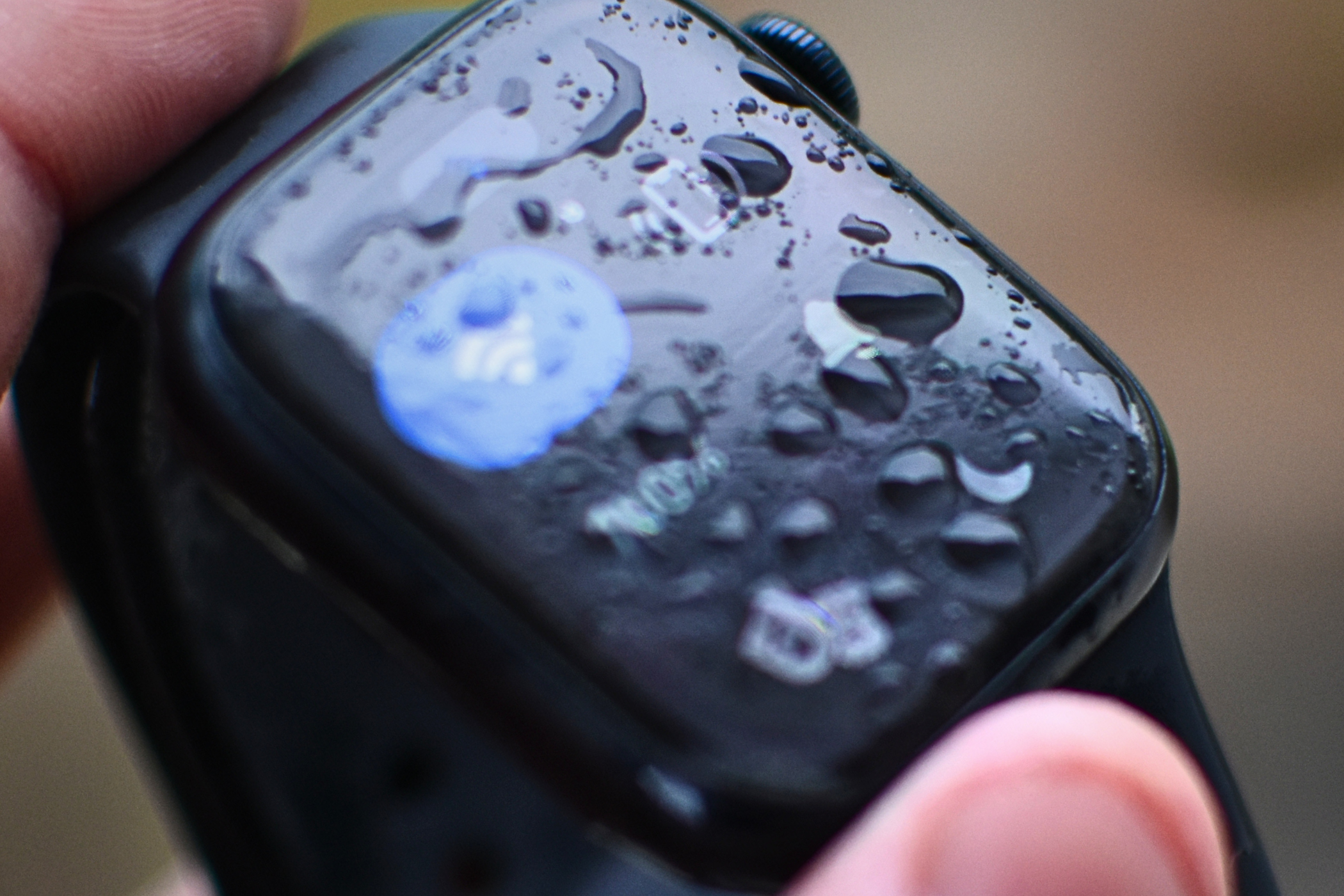 Apple Watch Series 8 with water droplets over the screen.
