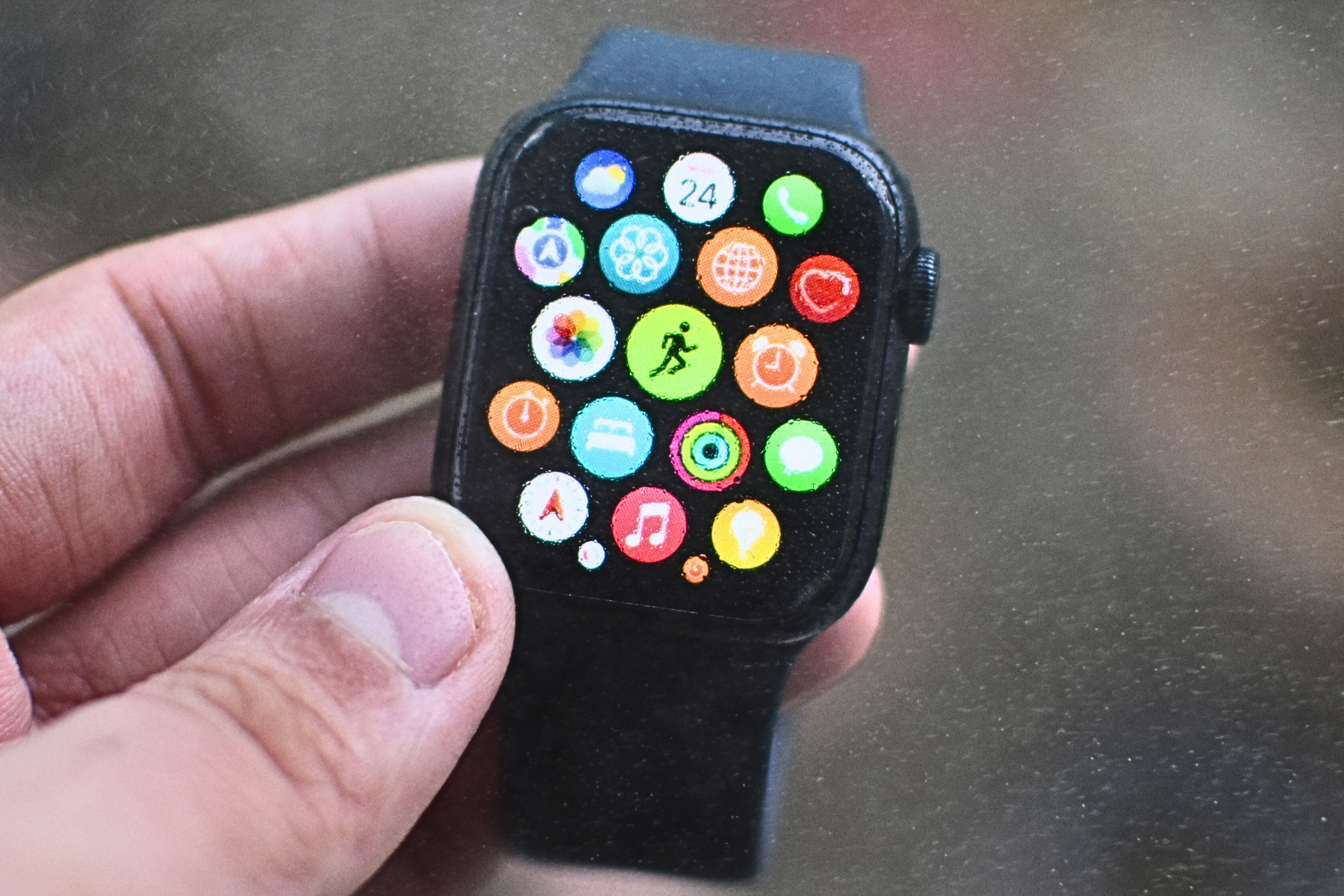 Apple Watch with tiny water droplets in the foreground and the background.