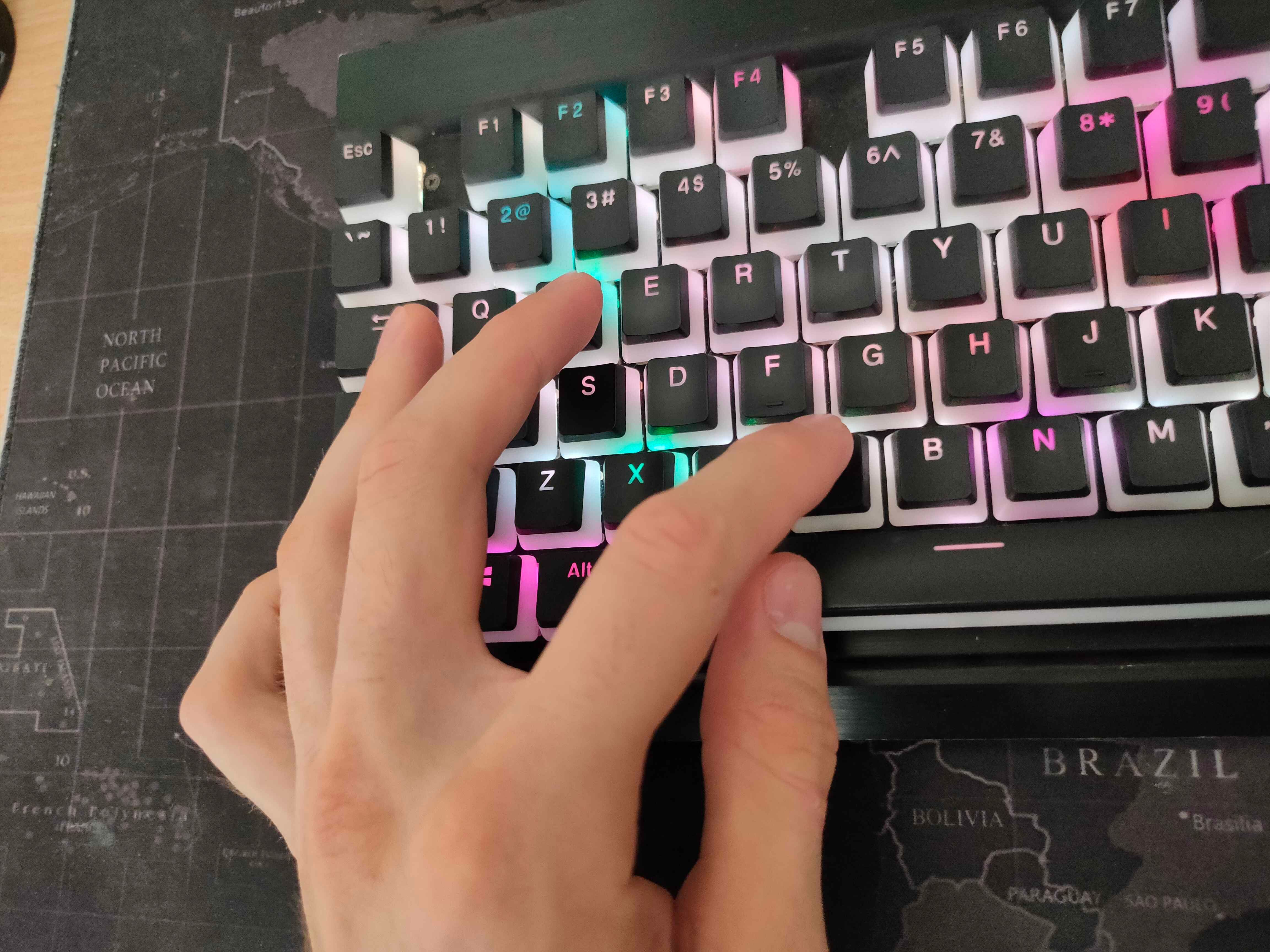 Fingers in awkward position on a keyboard.