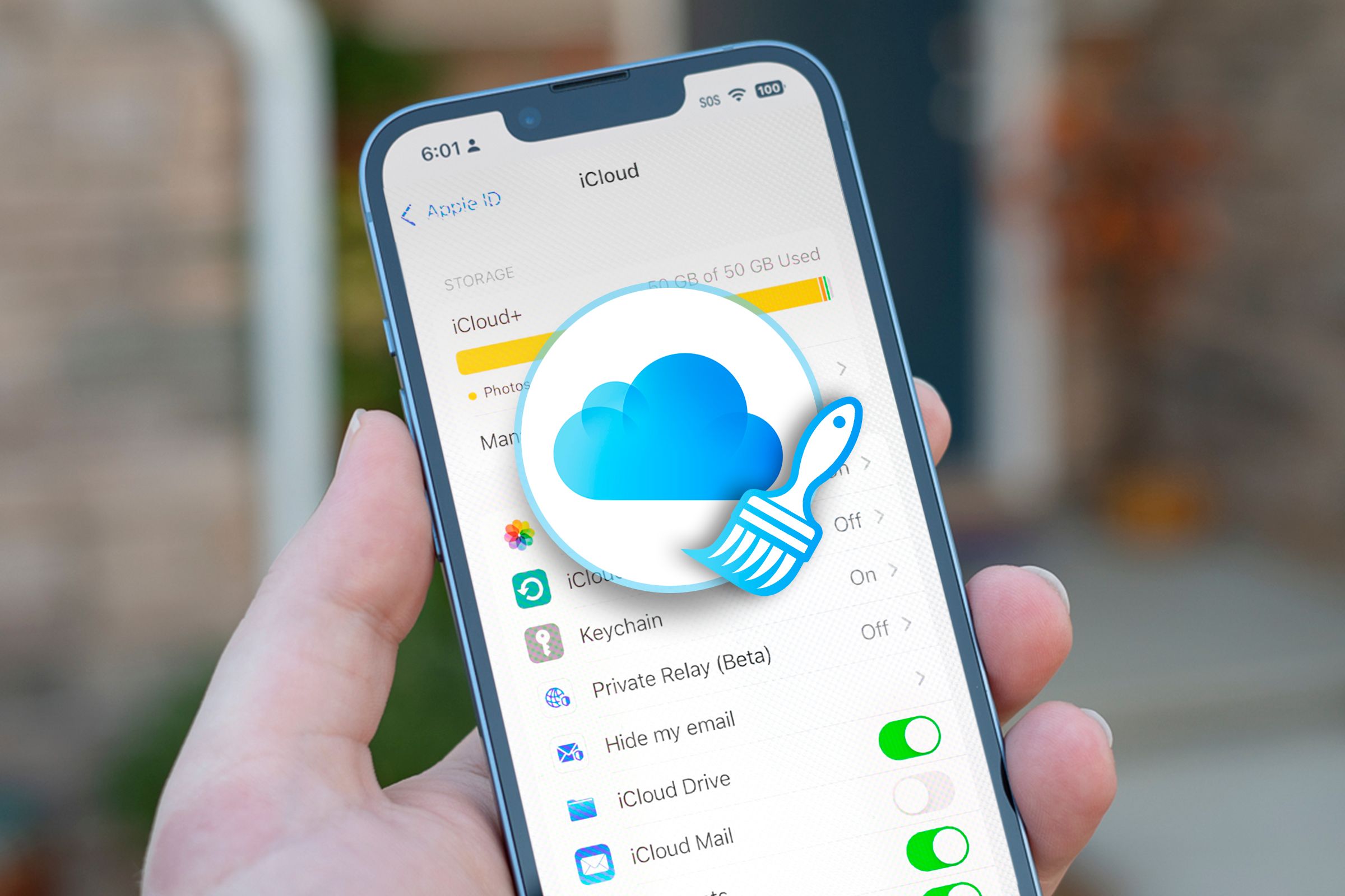 An iPhone on the iCloud storage screen with a cloud icon in the center and a cleaning icon.