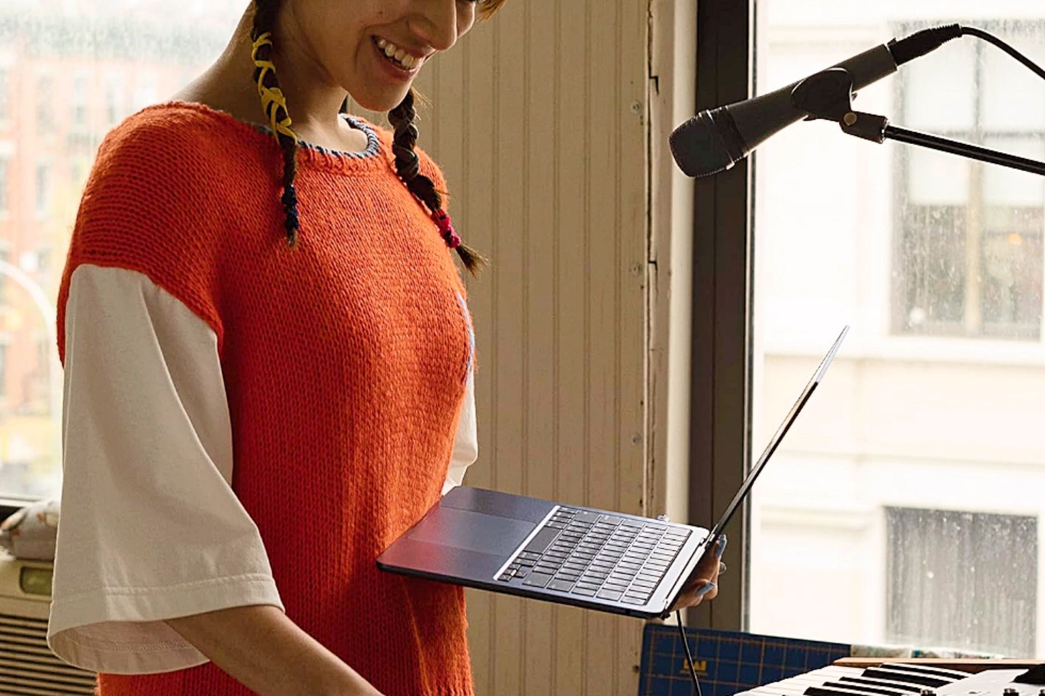 A woman using a MacBook Air M2 13-inch to make music