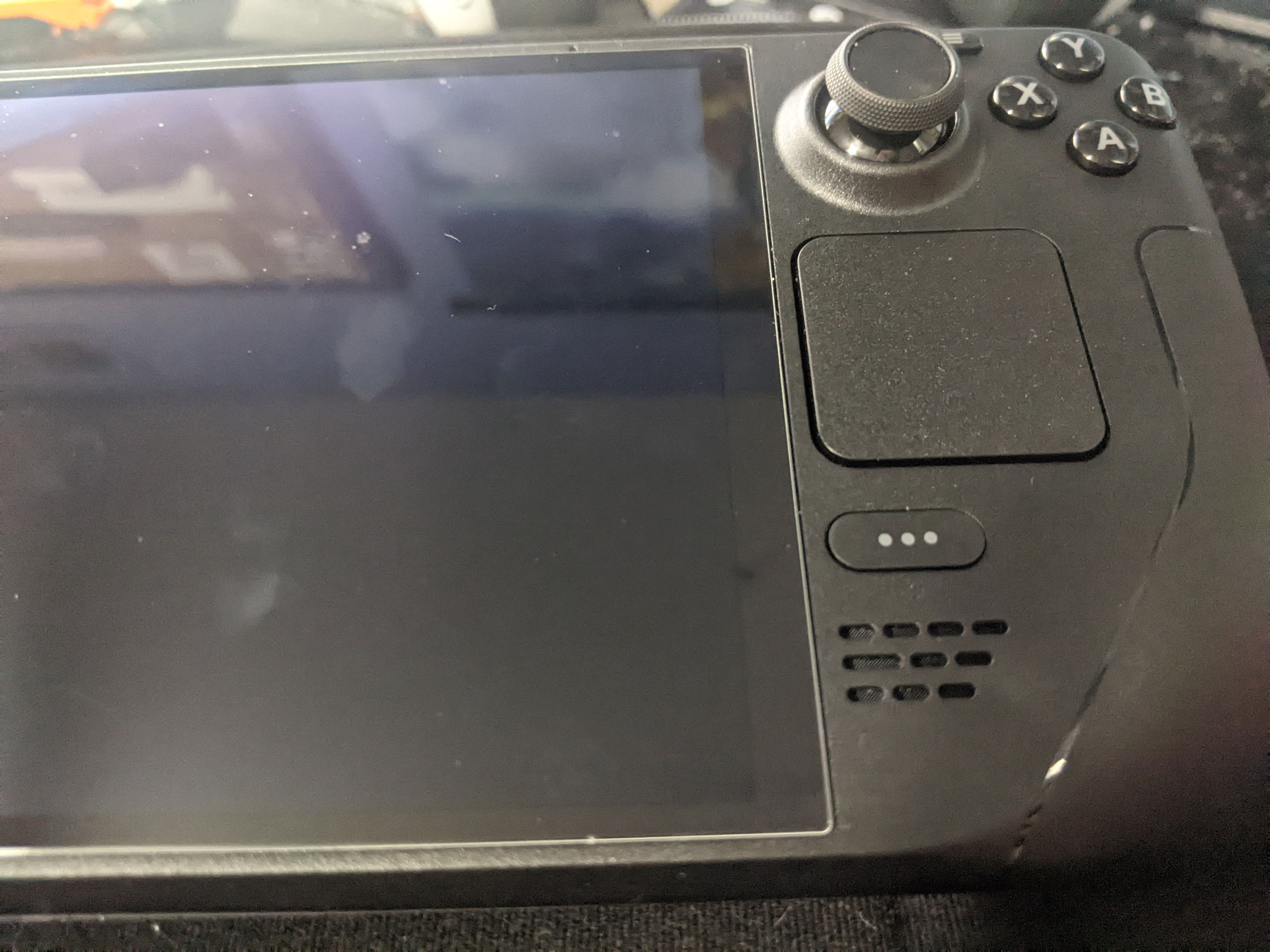 The right side of the Steam Deck OLED model with the trackpad underneath the joystick.